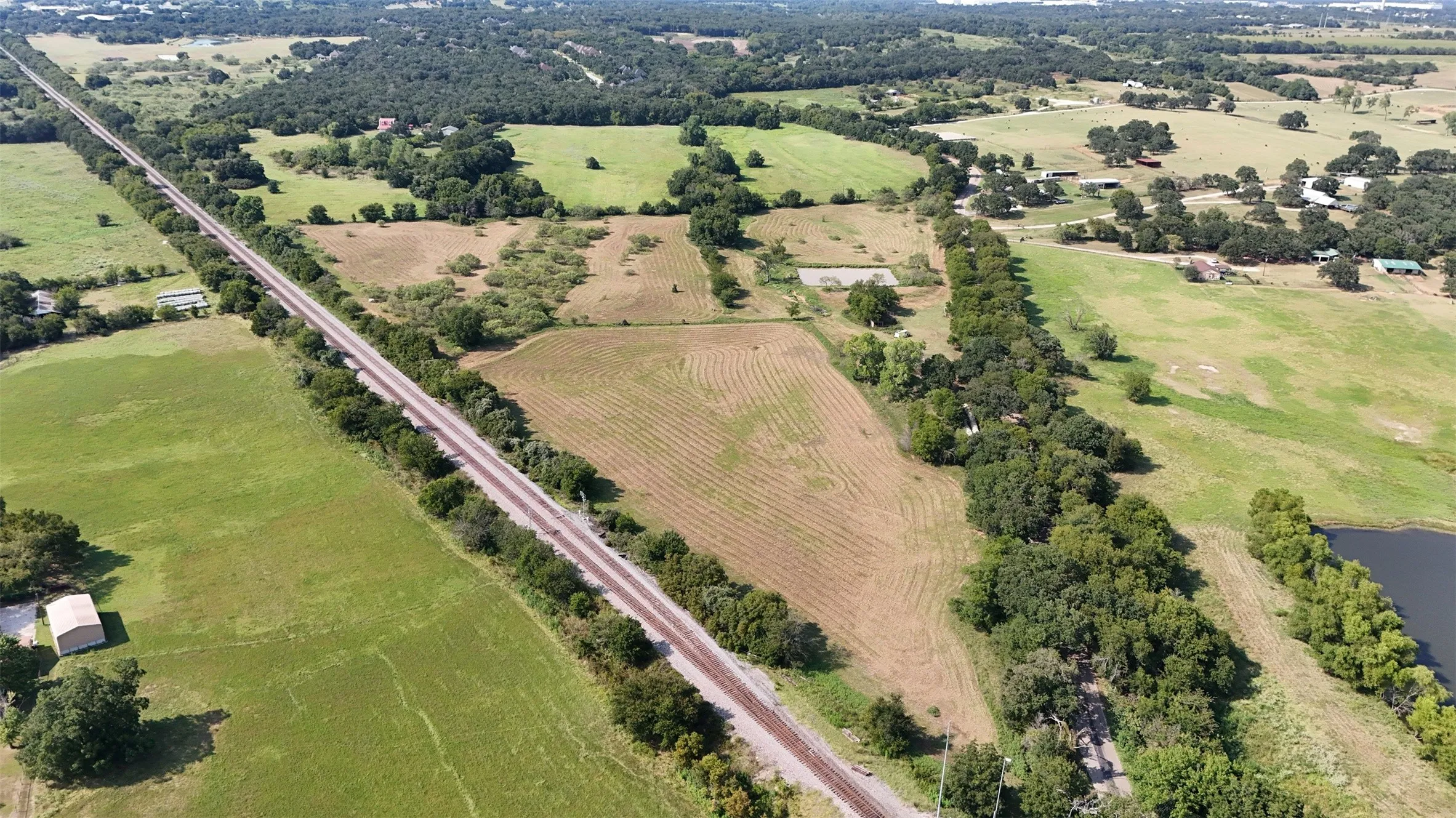 Aerial view of property's location with rural landscape and large plots for crops