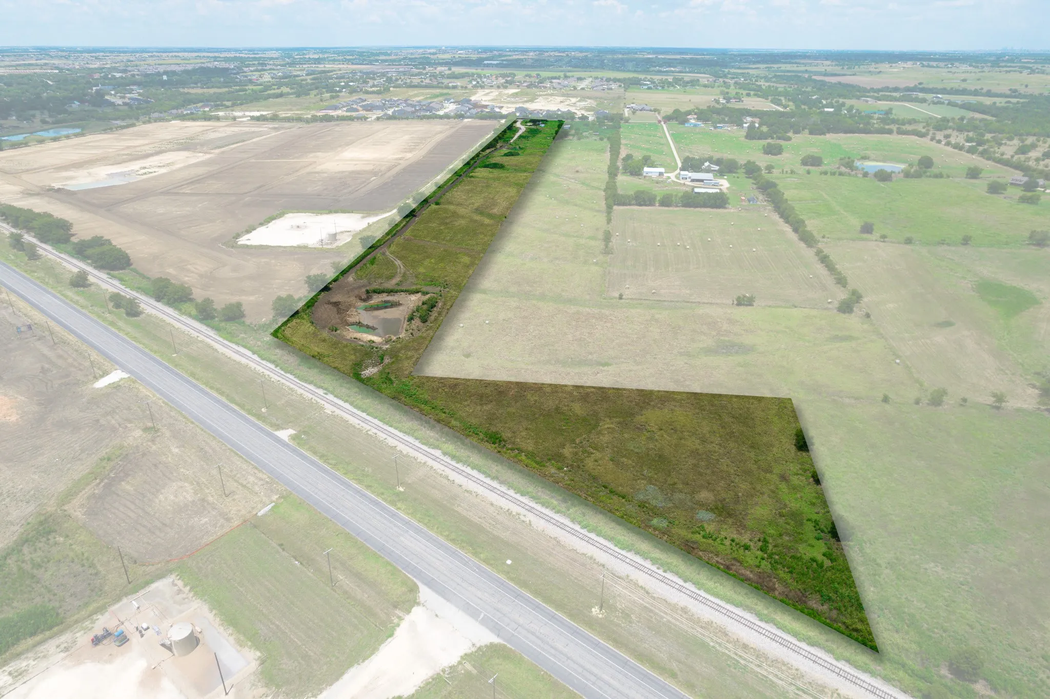 Aerial view of sparsely populated area featuring large plots for crops