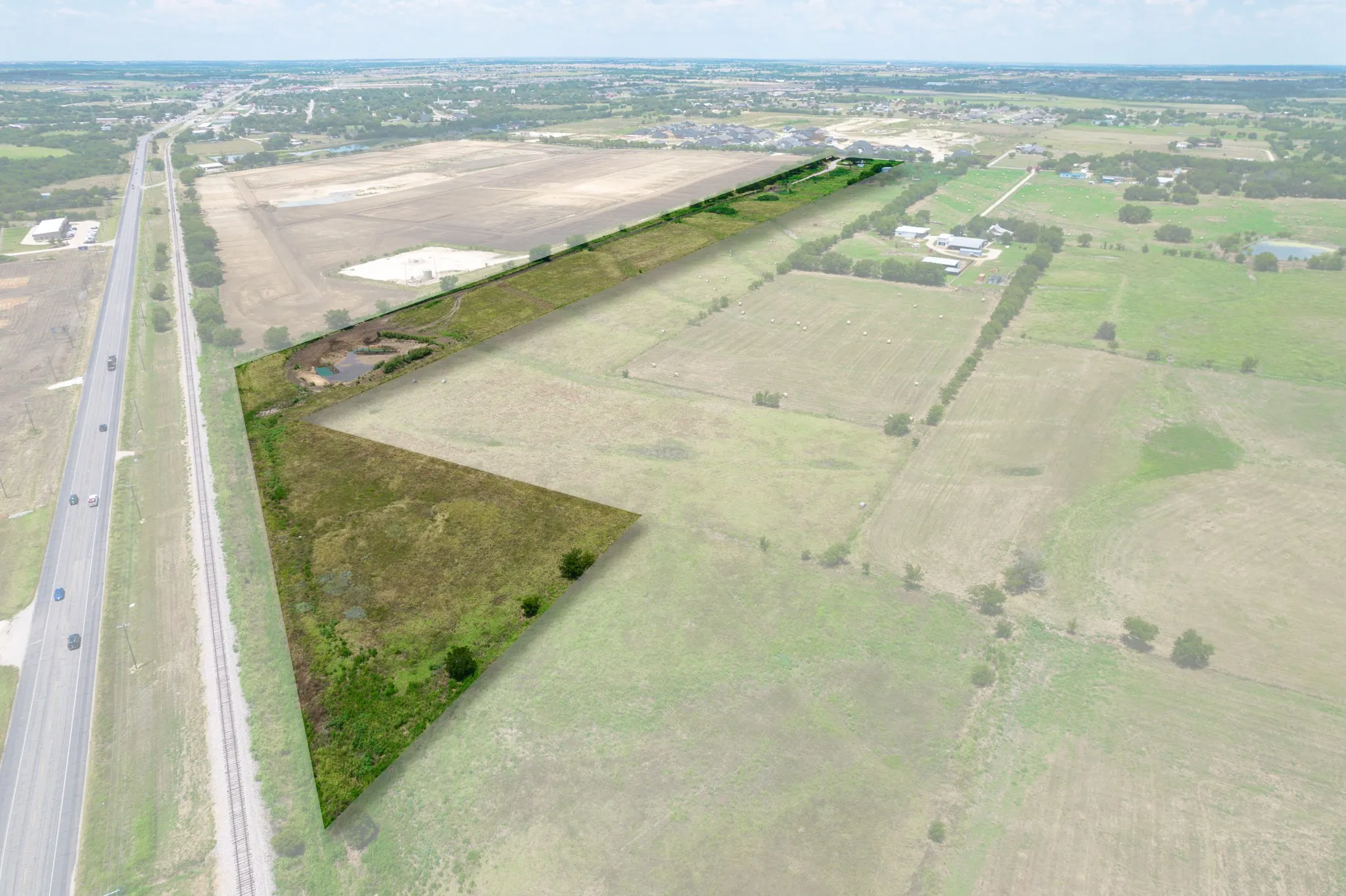 Aerial overview of property's location with rural landscape and large plots for crops