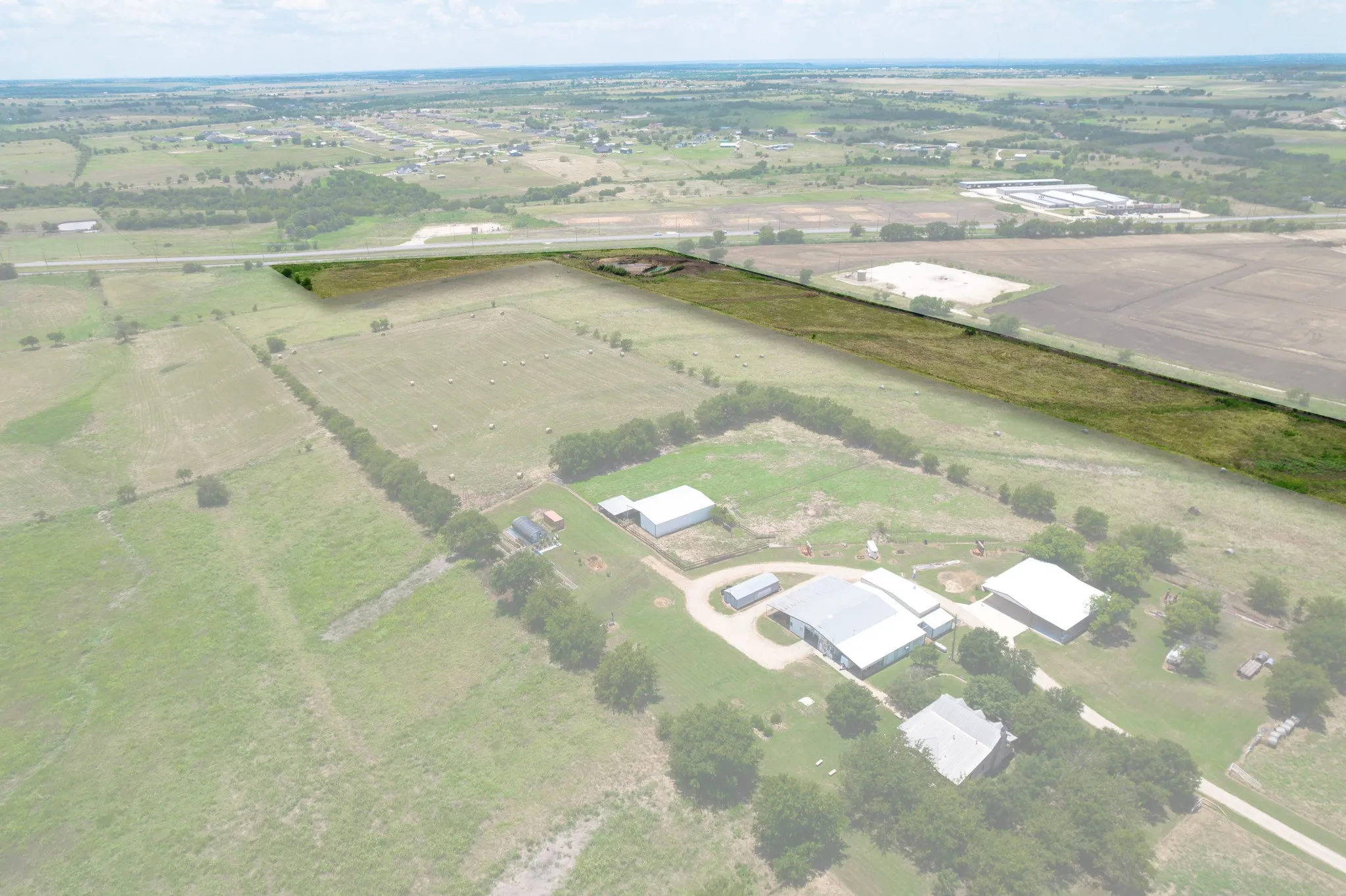 Aerial view of property's location featuring rural landscape and rows of crops