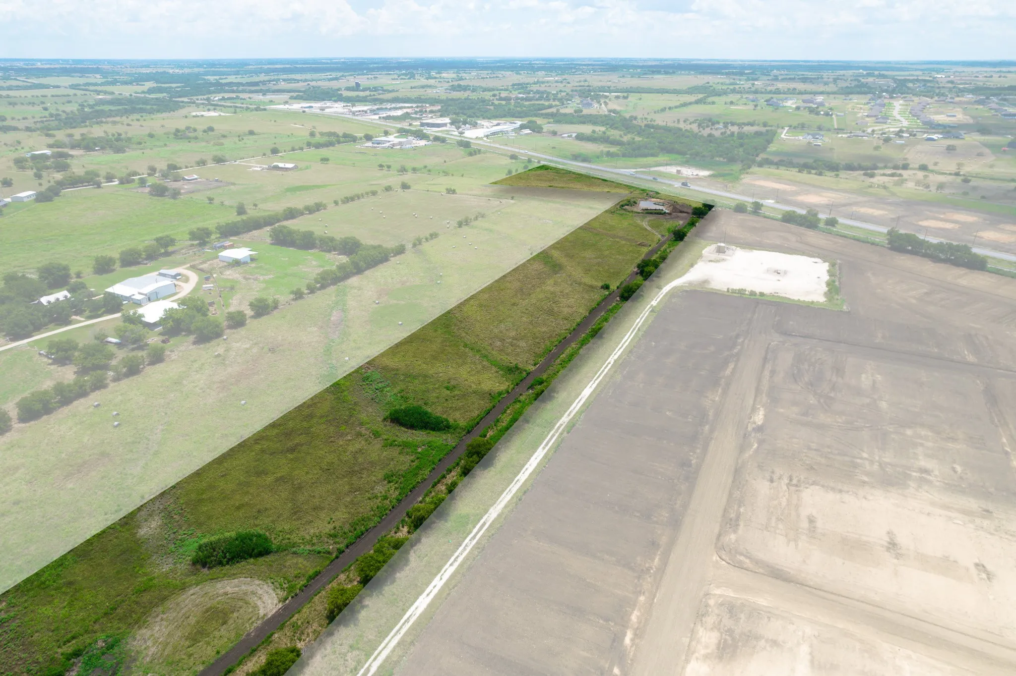 Aerial view of property and surrounding area featuring rural landscape