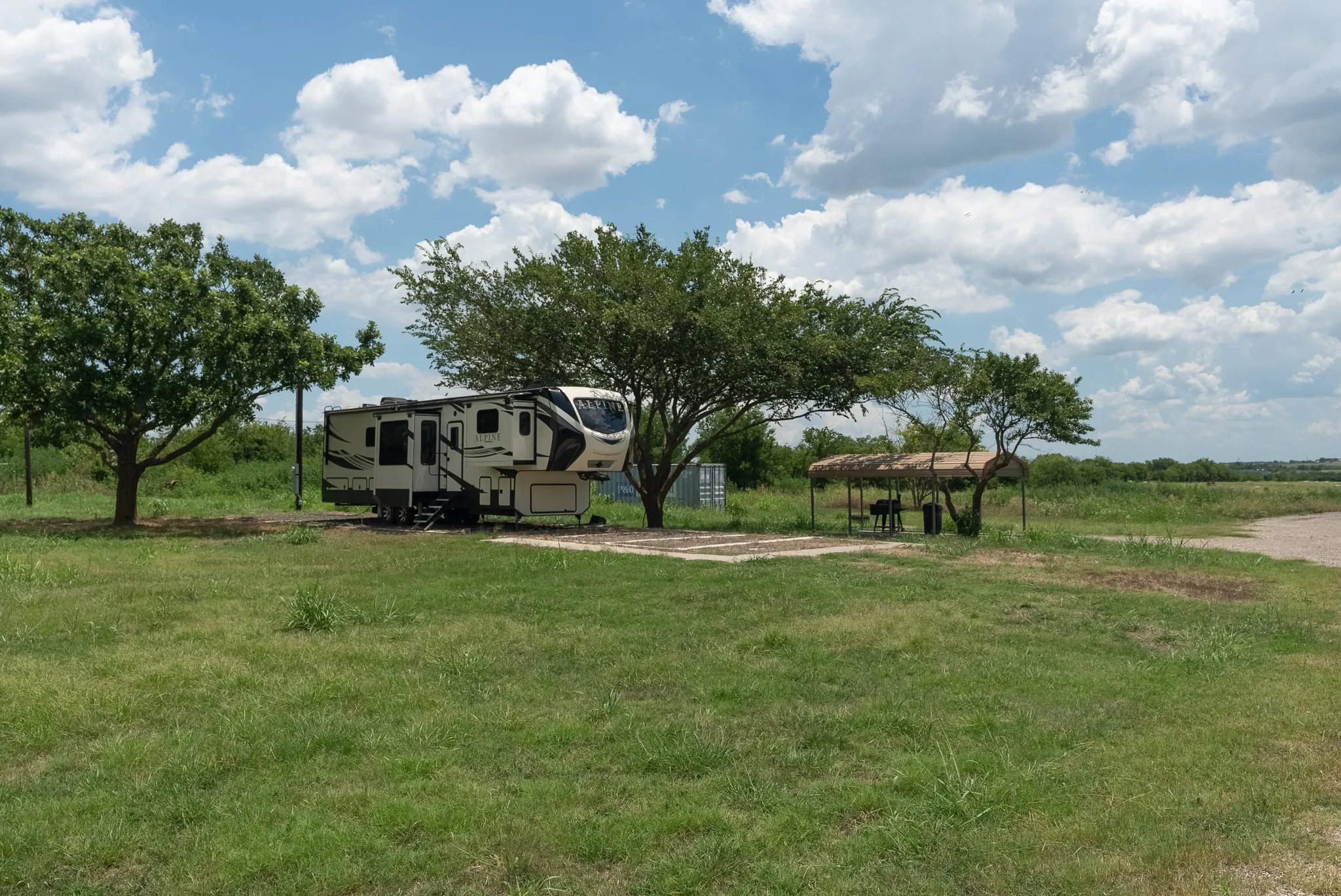 View of community with a carport and a lawn