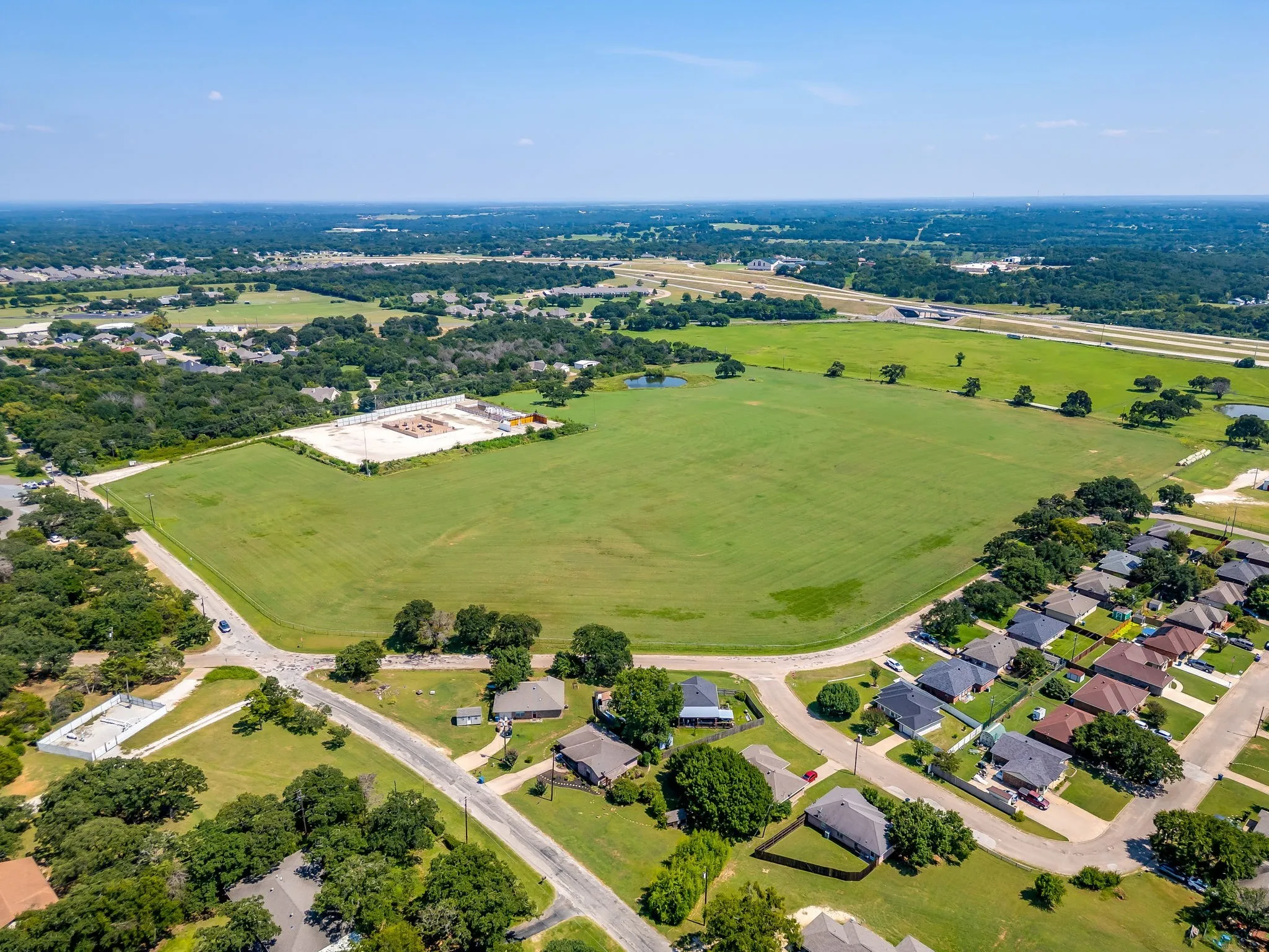 Aerial overview of property's location with nearby suburban area and a large body of water
