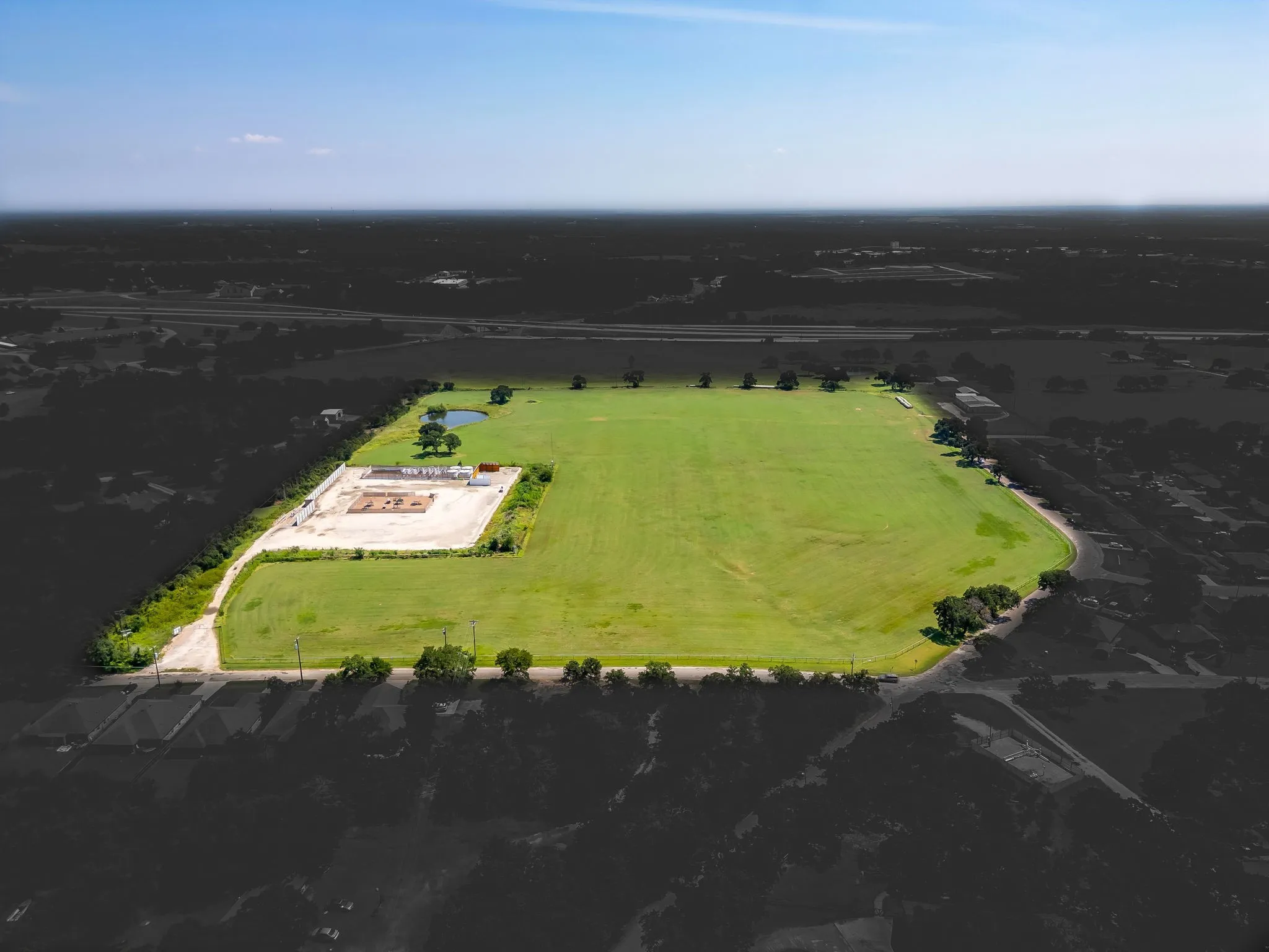 Aerial view of sparsely populated area with property boundaries highlighted and rows of crops