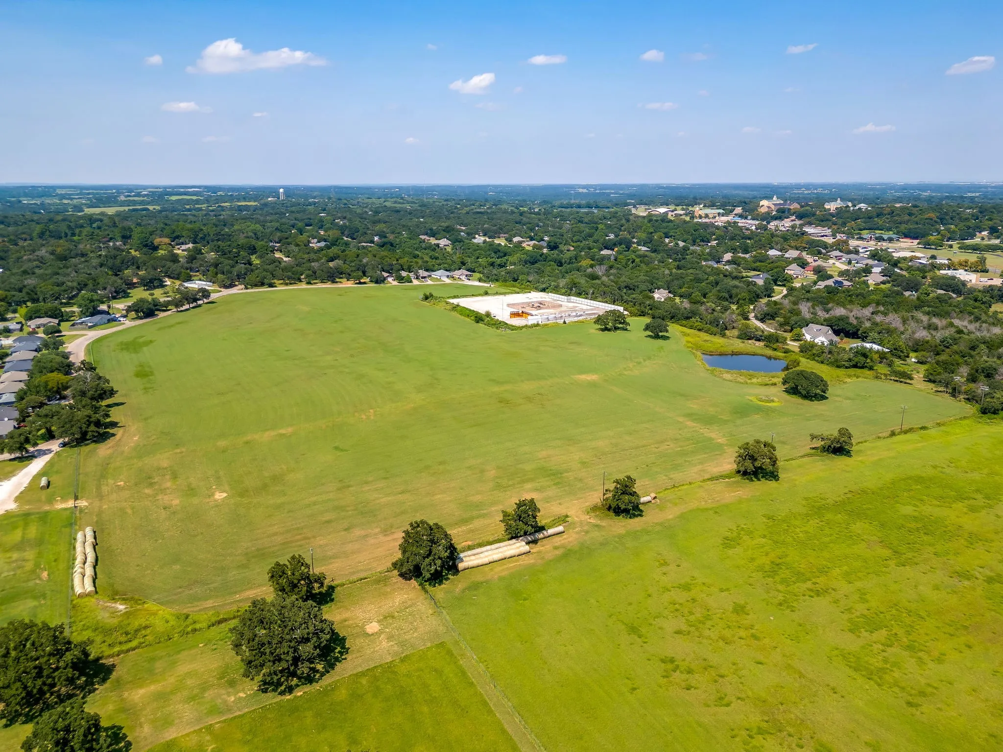 Aerial view of a tree filled landscape and a large body of water