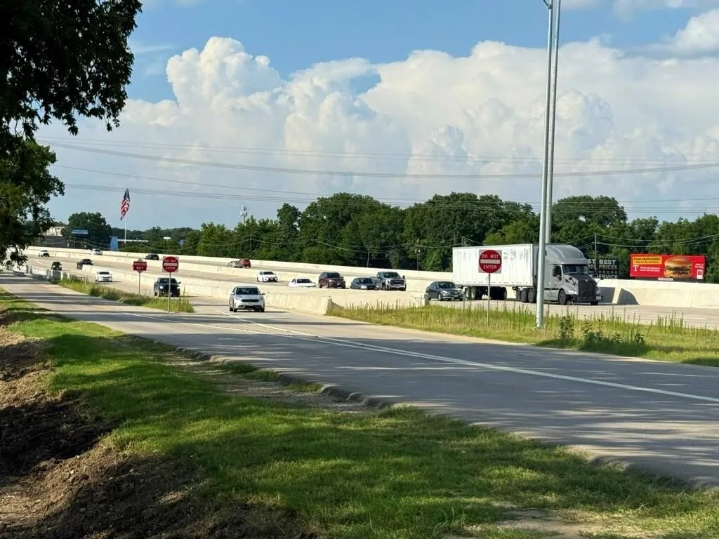 View of asphalt road with traffic signs