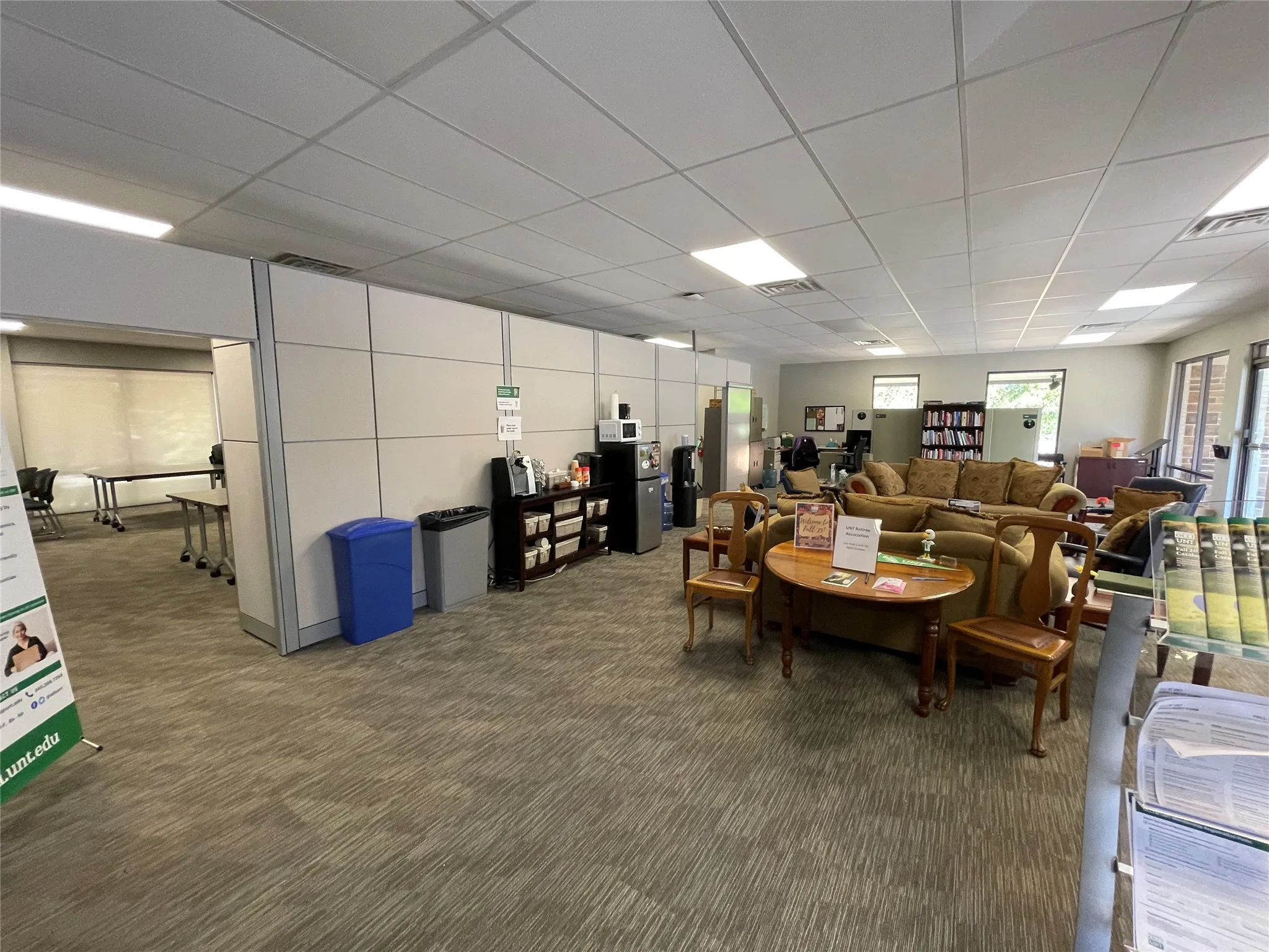 Carpeted living area featuring a paneled ceiling