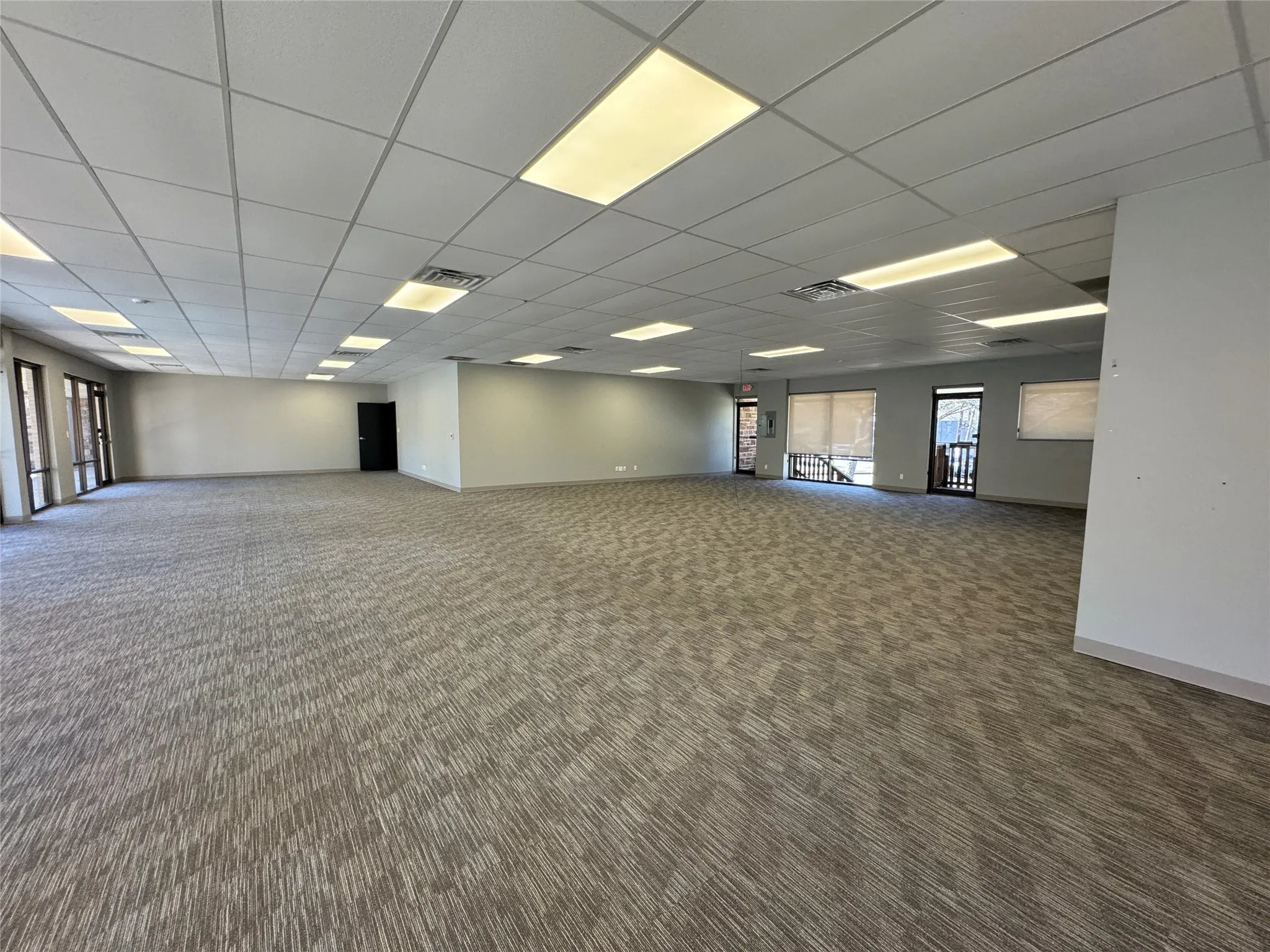 Spare room featuring carpet and a paneled ceiling