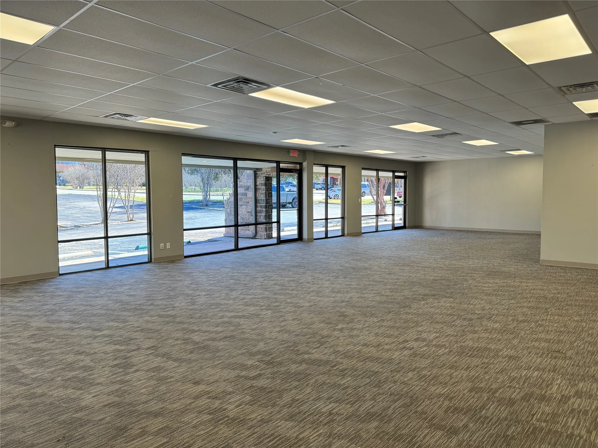 Spare room featuring a drop ceiling and carpet floors