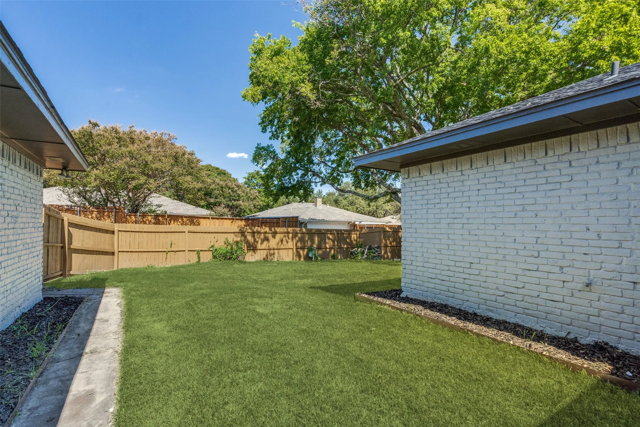 View of fenced backyard