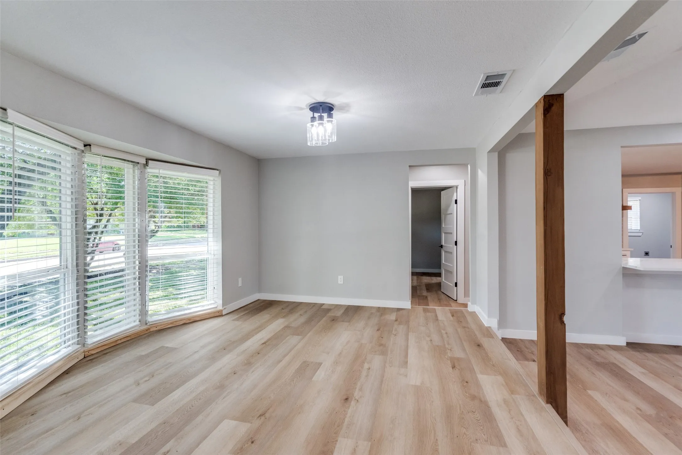 Empty room with plenty of natural light and light wood-type flooring