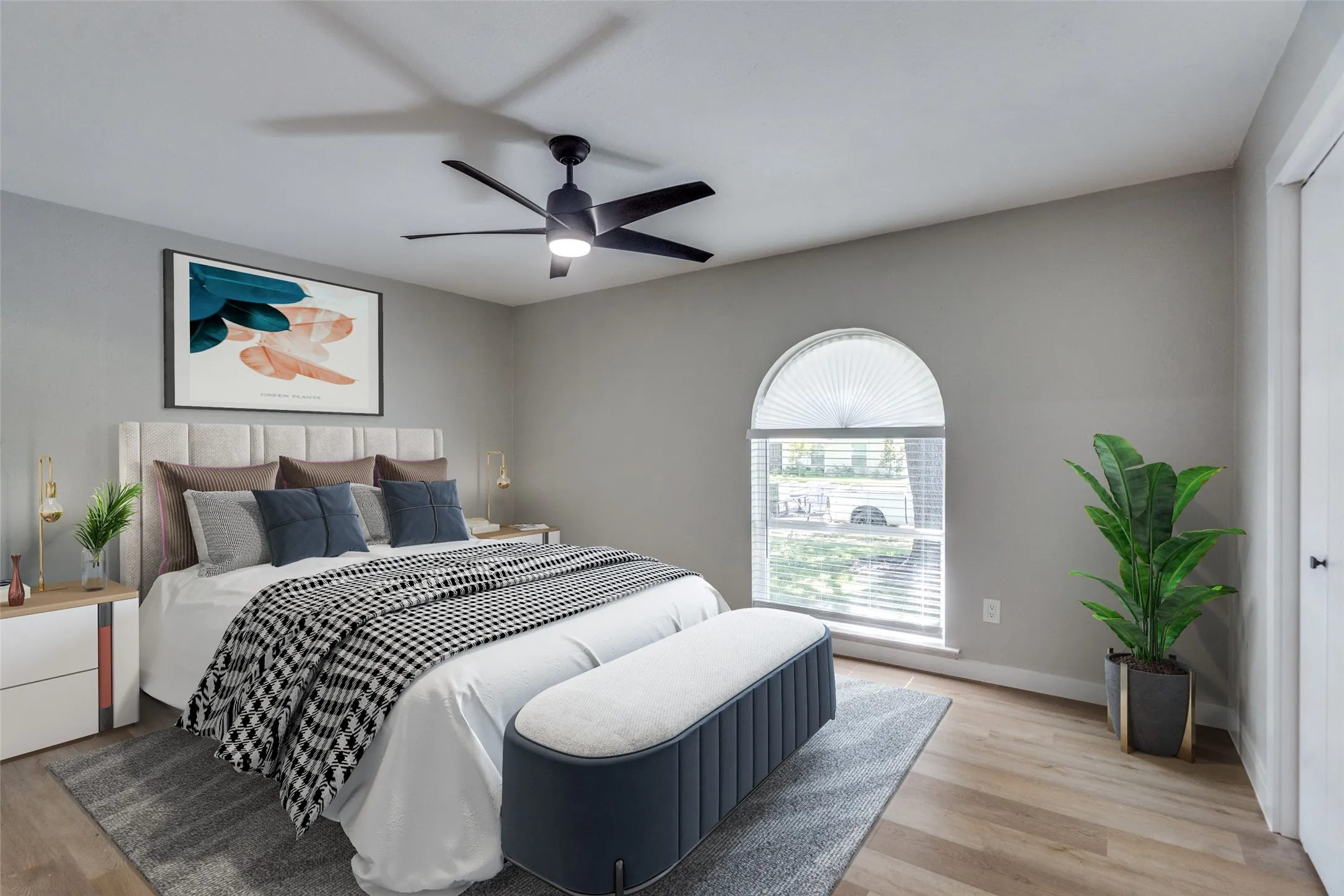 Bedroom with light wood-style flooring and a ceiling fan