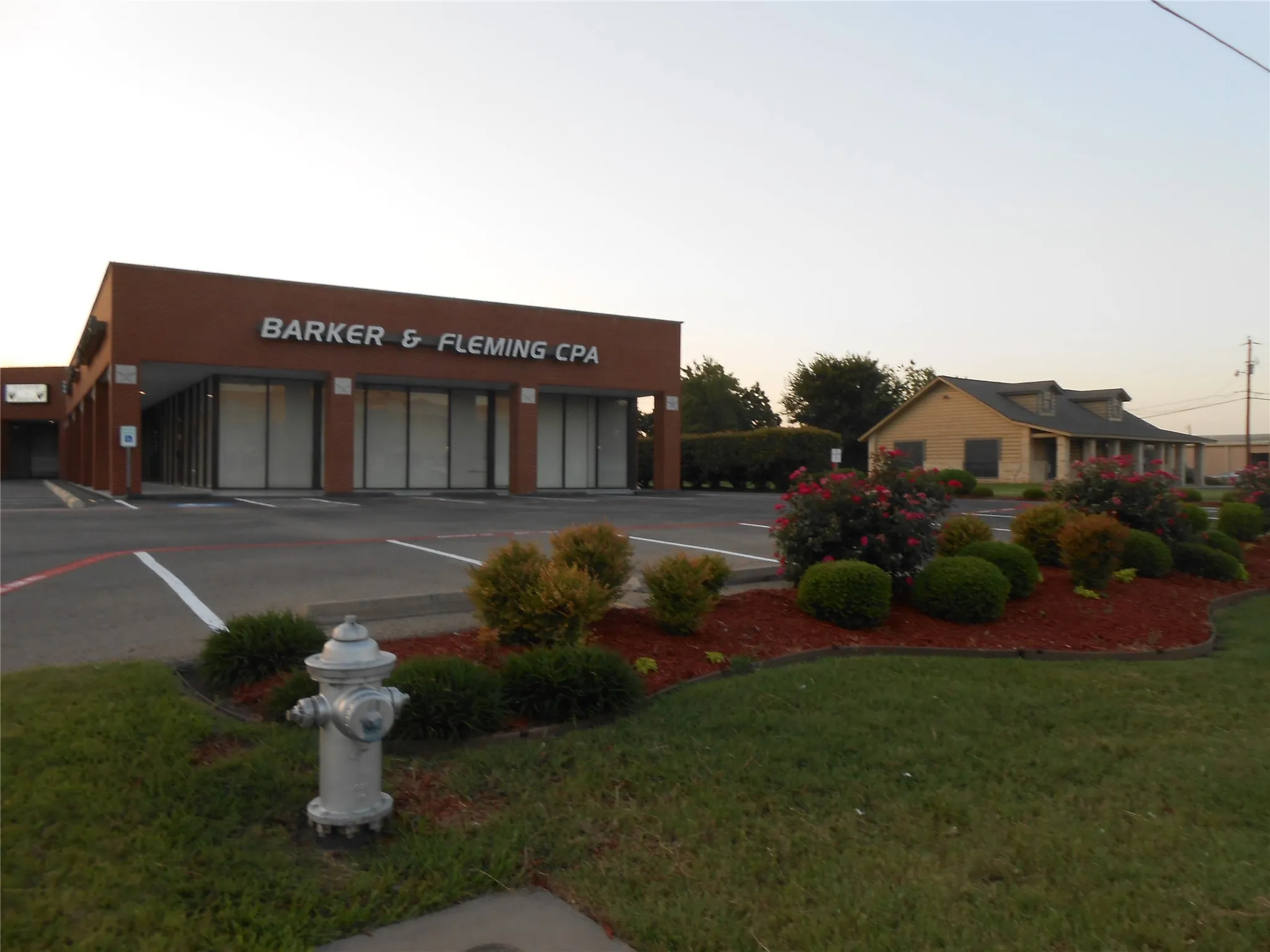 Property at dusk with uncovered parking