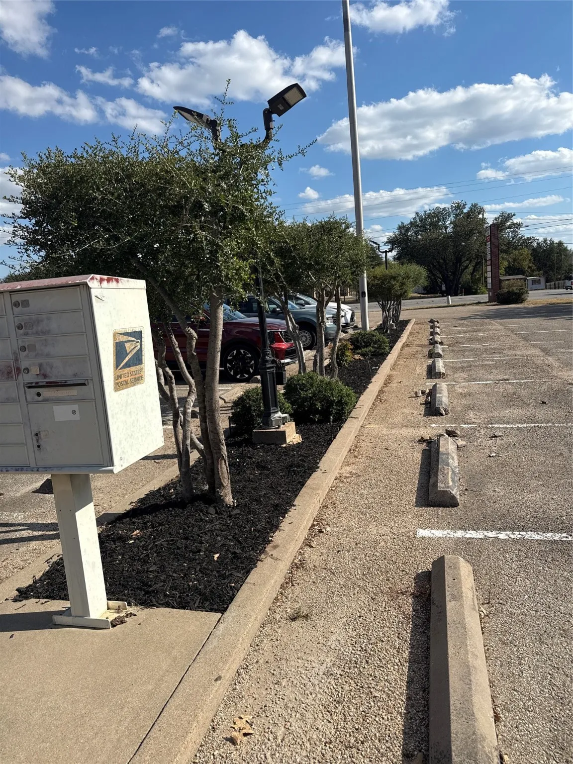 View of parking with mail area