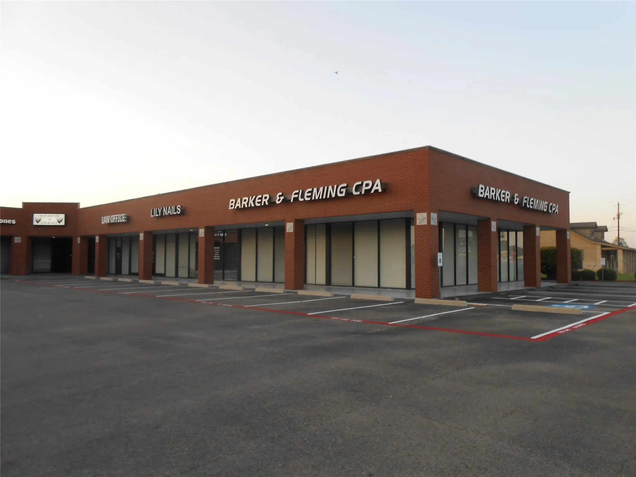 View of building exterior with uncovered parking