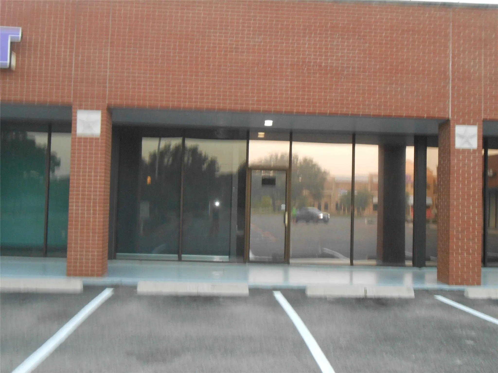 Doorway to property featuring uncovered parking and elevator