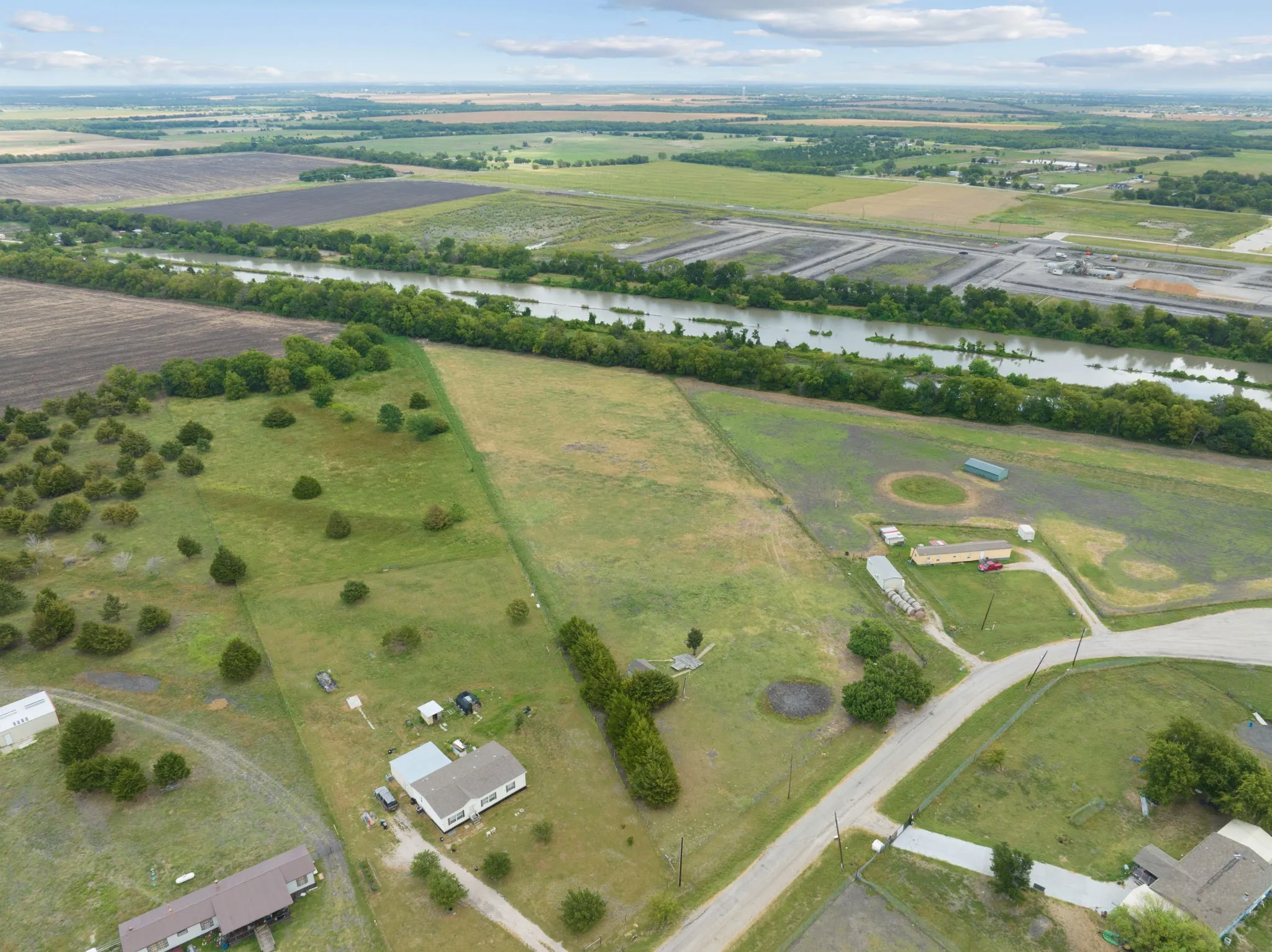 Aerial view of property's location featuring rural landscape and a nearby body of water