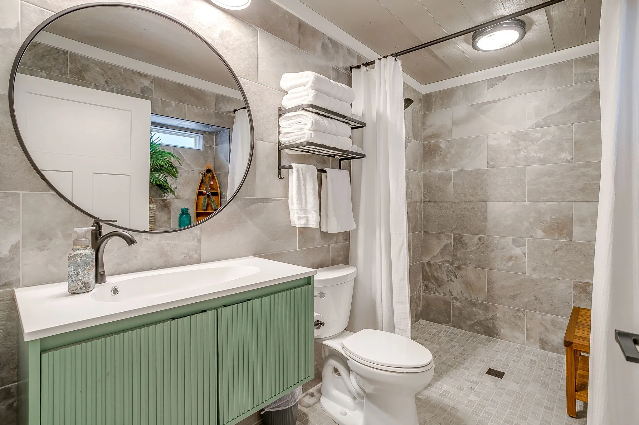 Full bath with tile walls, vanity, and a tile shower