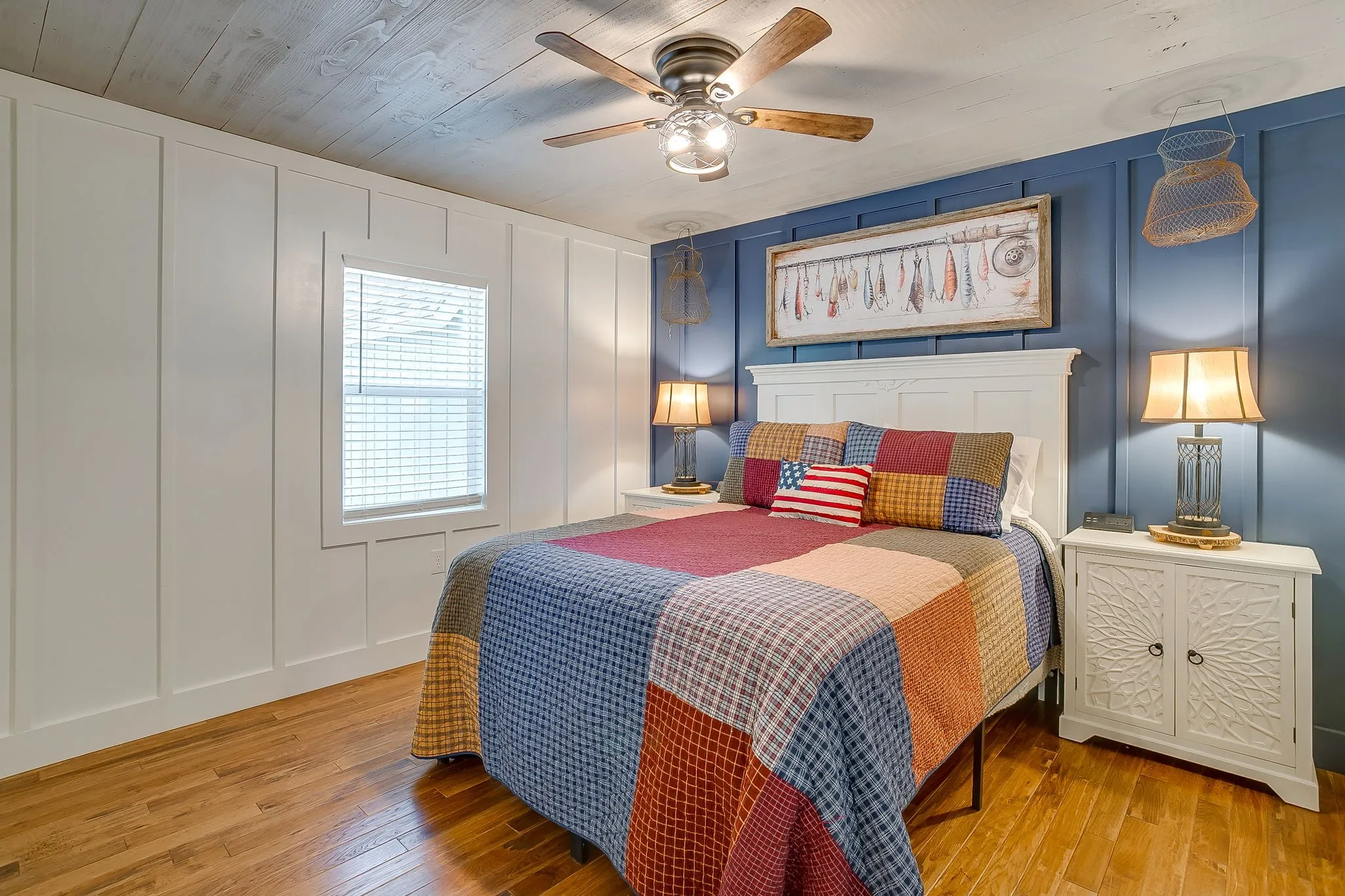 Bedroom featuring a decorative wall, hardwood / wood-style floors, and ceiling fan