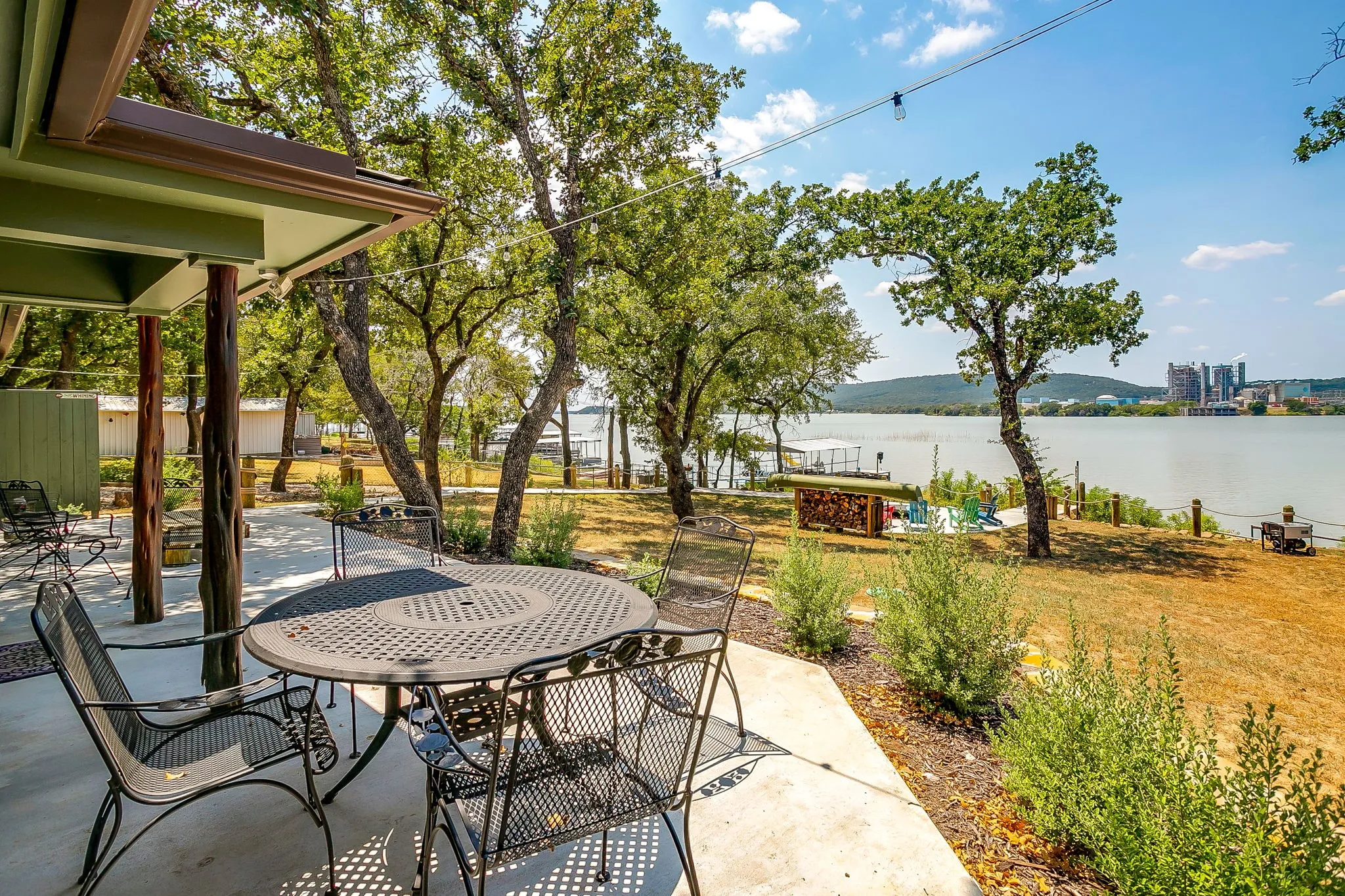 View of patio featuring a water view and outdoor dining area