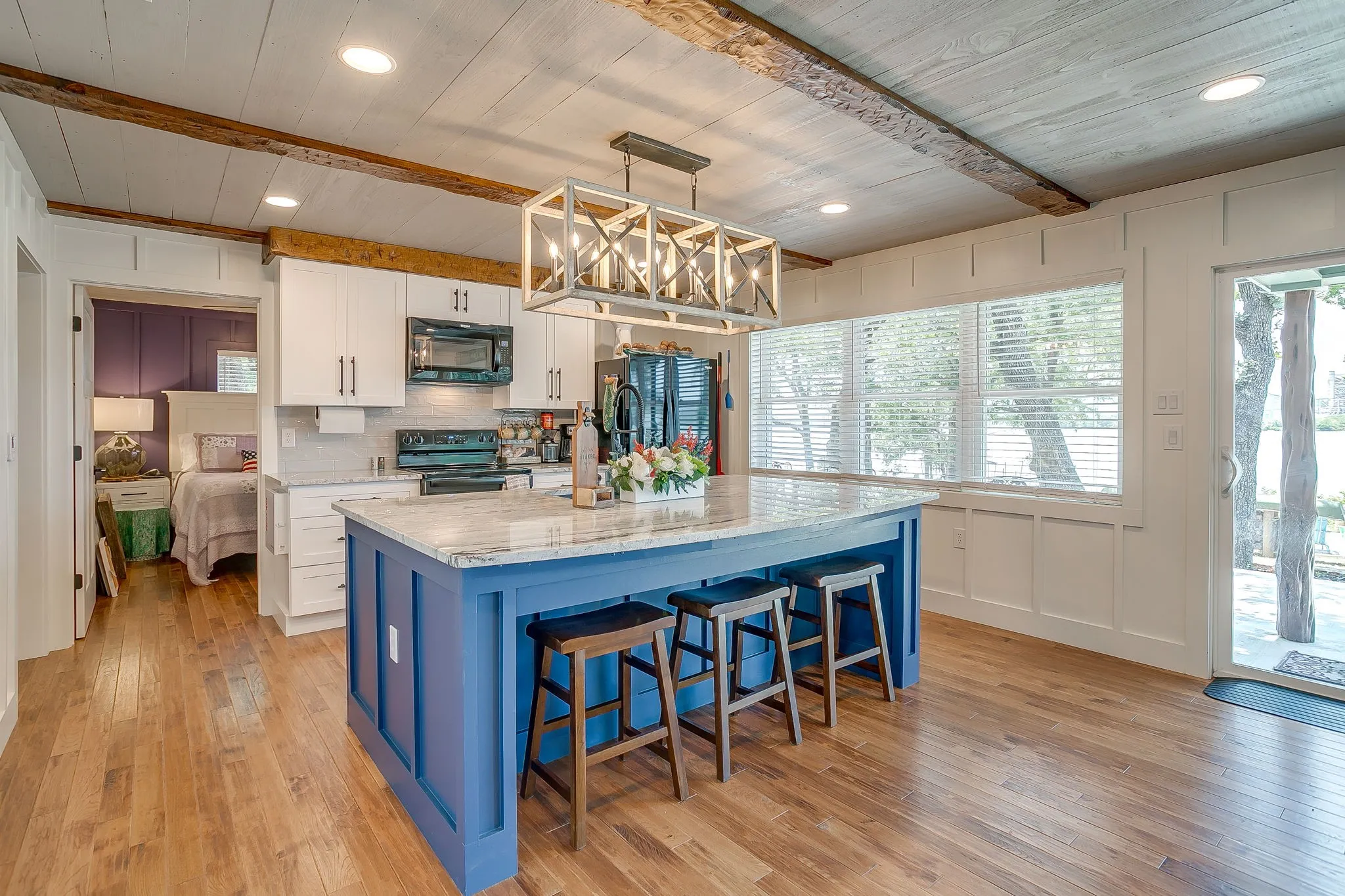 Kitchen with beam ceiling, white cabinets, backsplash, light wood finished floors, and recessed lighting
