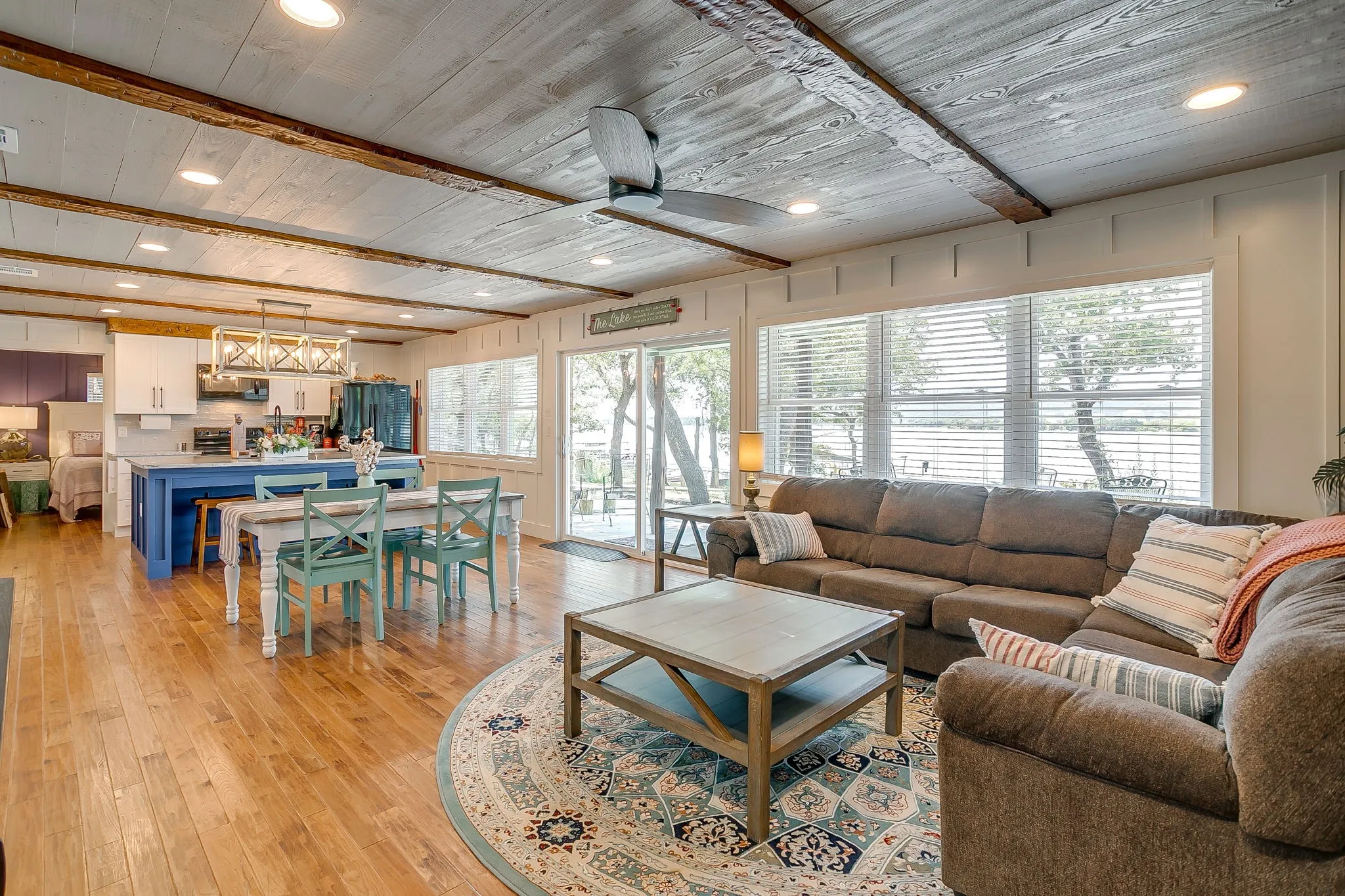 Living area with recessed lighting, light wood-style flooring, a wooden ceiling with exposed beams, and a ceiling fan