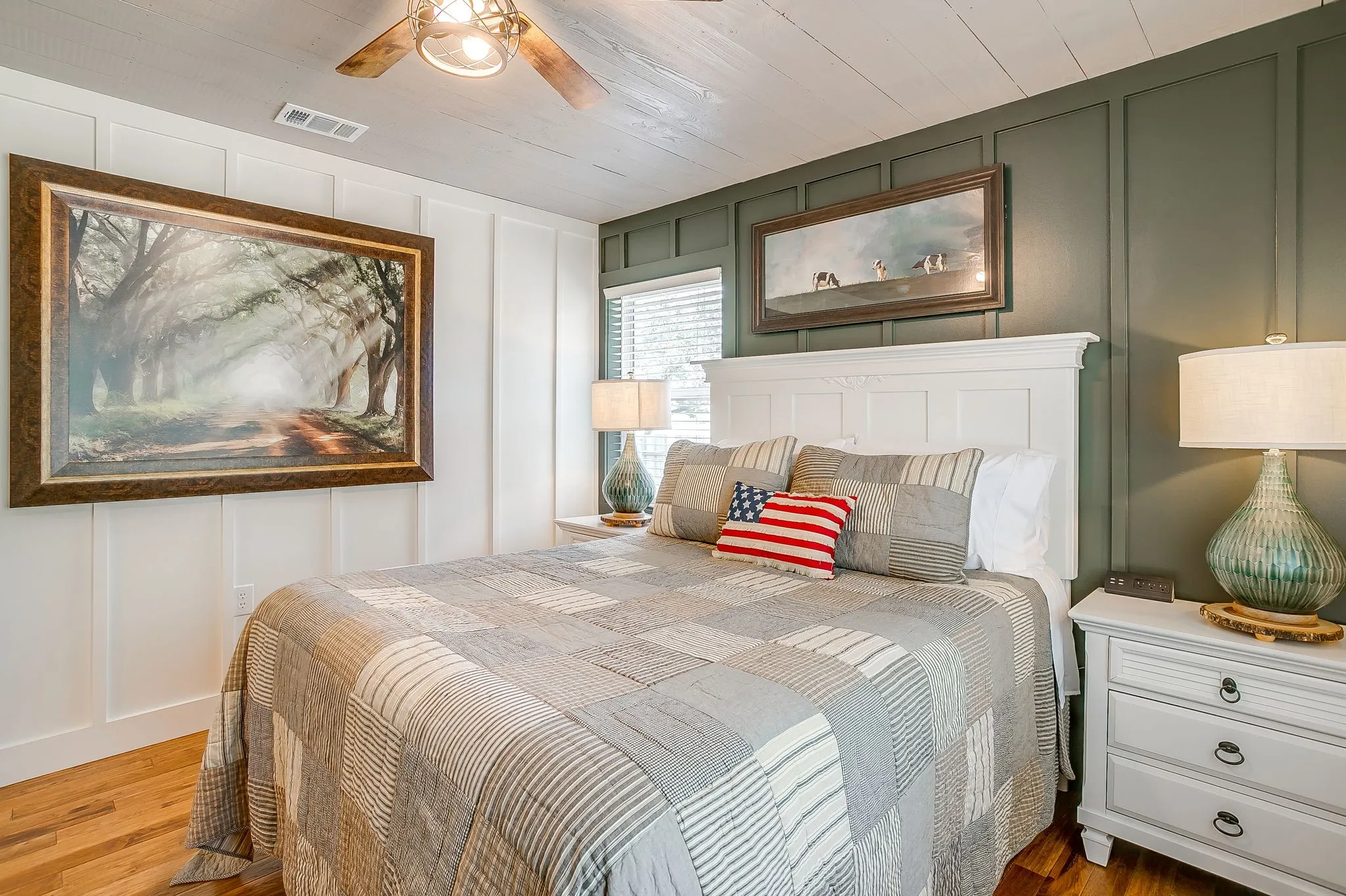 Bedroom featuring a decorative wall, wood finished floors, and ceiling fan