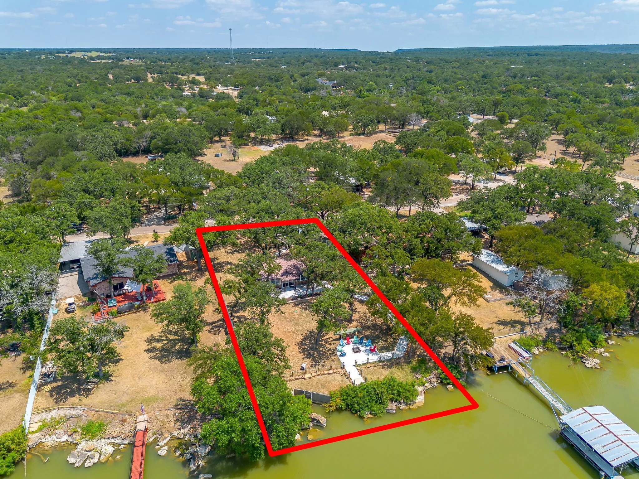 Aerial overview of property's location featuring property parcel outlined and a nearby body of water
