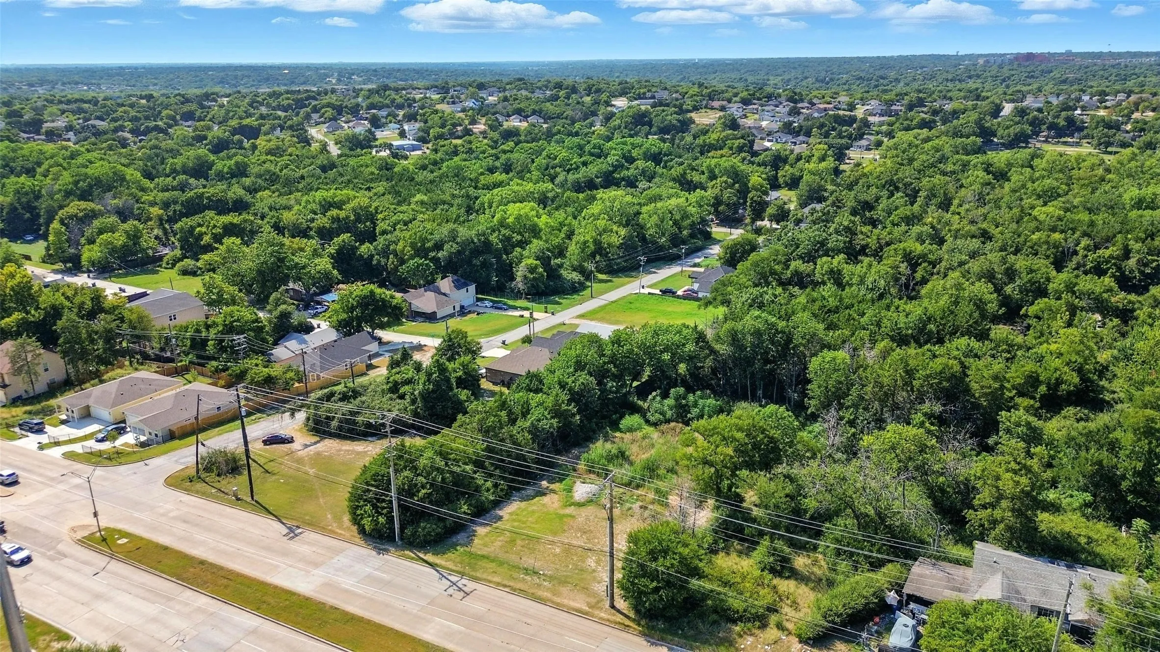 Aerial view of residential area featuring a forest