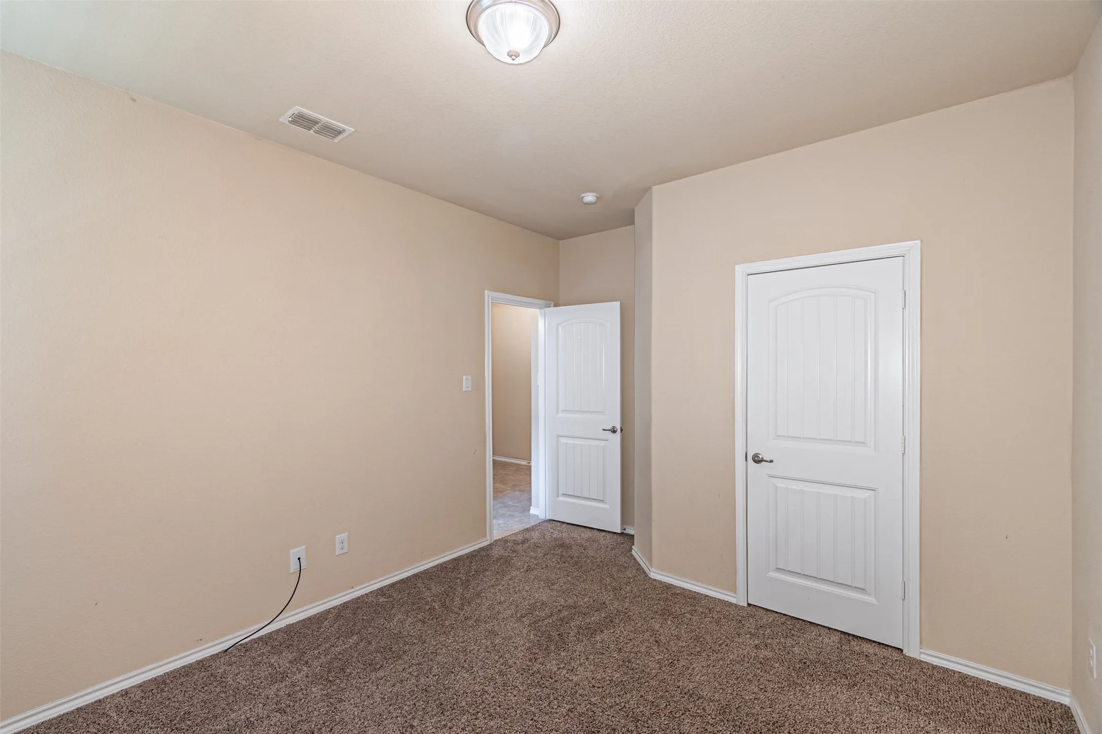 Unfurnished bedroom featuring carpet floors and baseboards