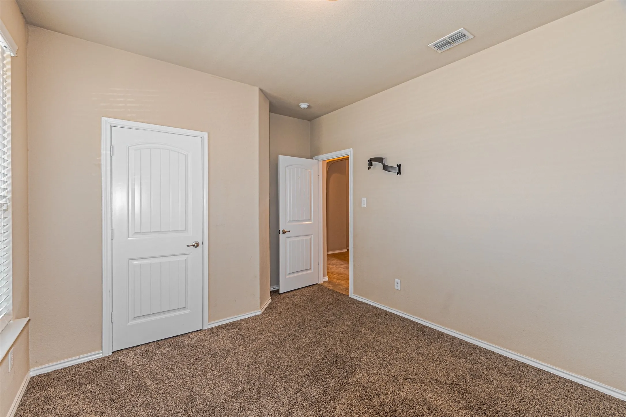 Unfurnished bedroom with carpet and baseboards