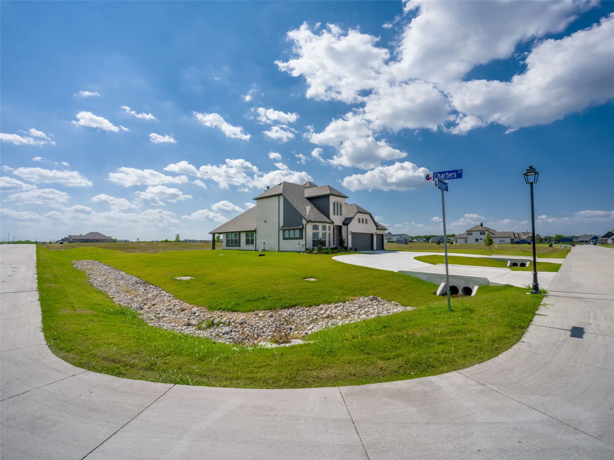 View of front of property featuring concrete driveway and a front yard