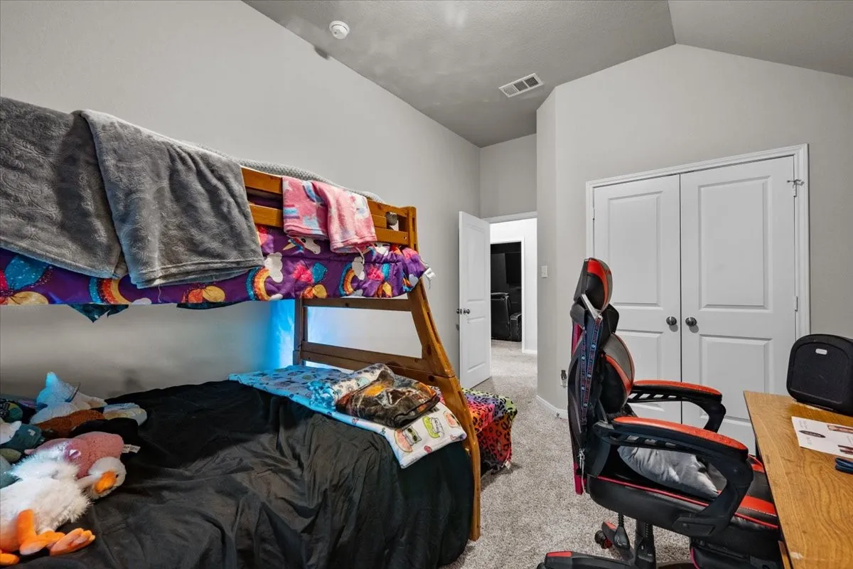 Bedroom featuring carpet and a closet