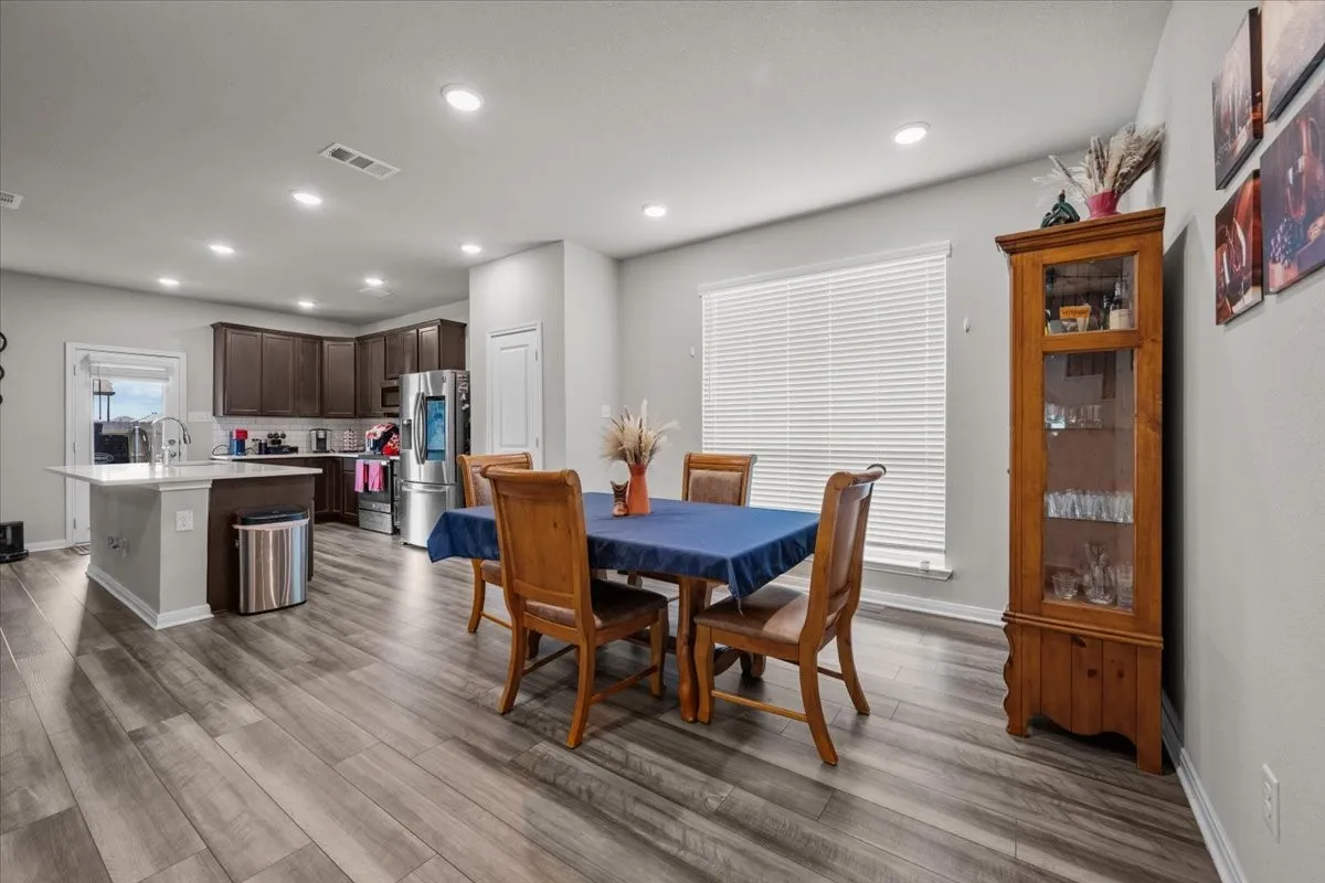 Dining area featuring wood finished floors and recessed lighting