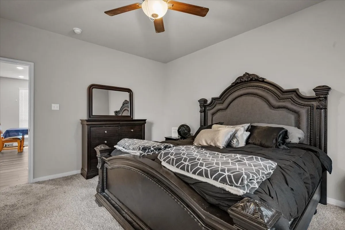 Bedroom featuring light colored carpet and a ceiling fan