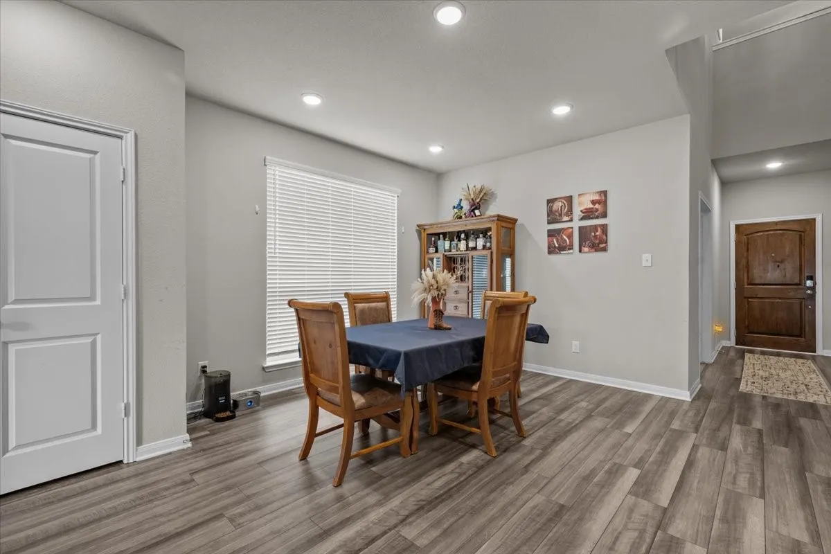 Dining room with recessed lighting and wood finished floors