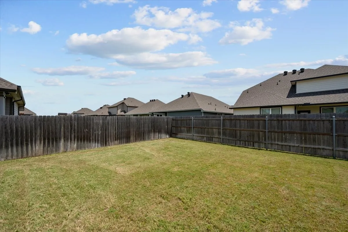 Fenced backyard with a residential view