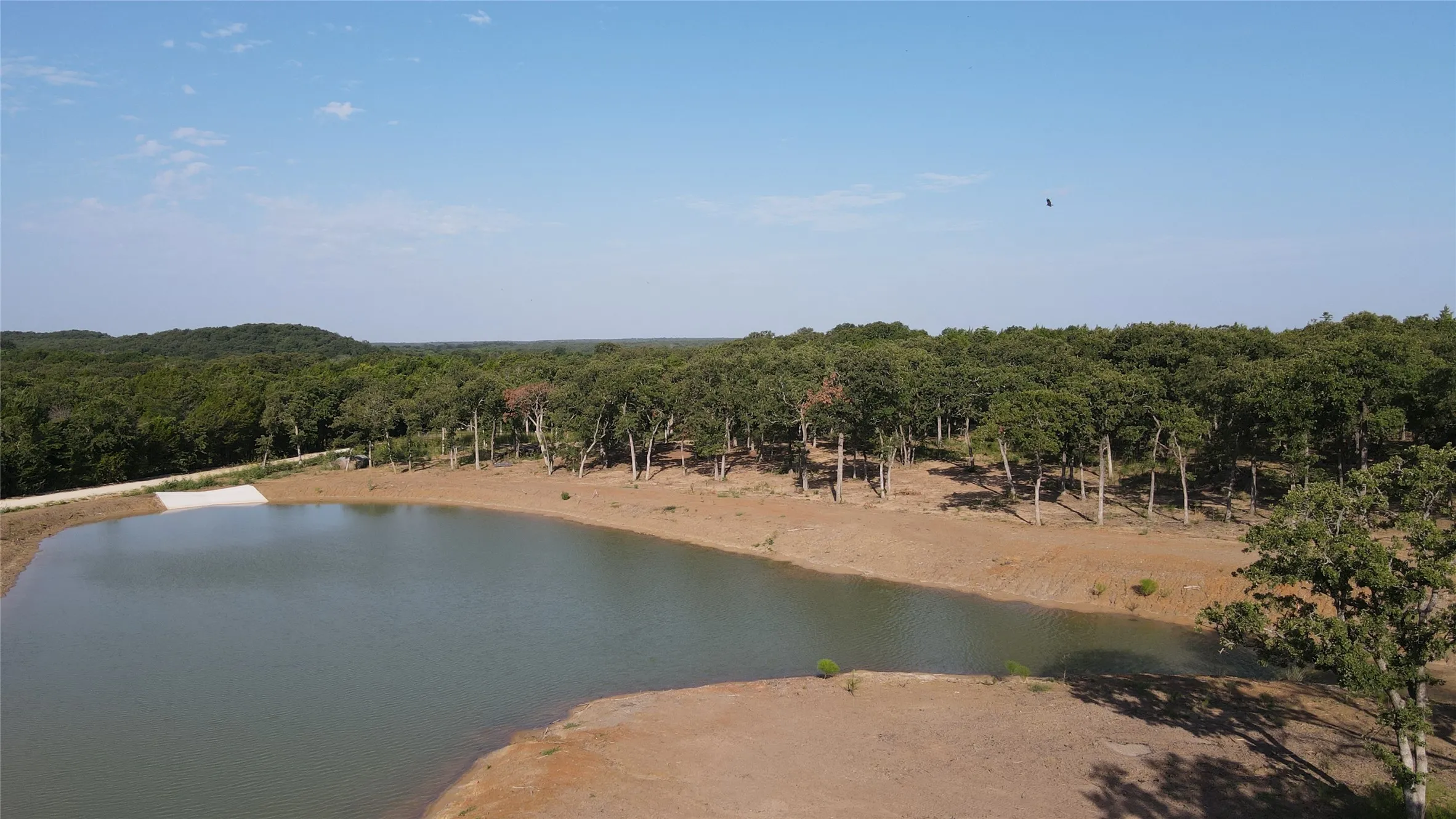 Water view with a heavily wooded area