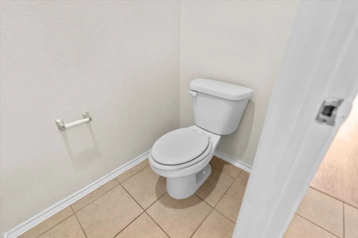 Bathroom with baseboards and tile patterned floors