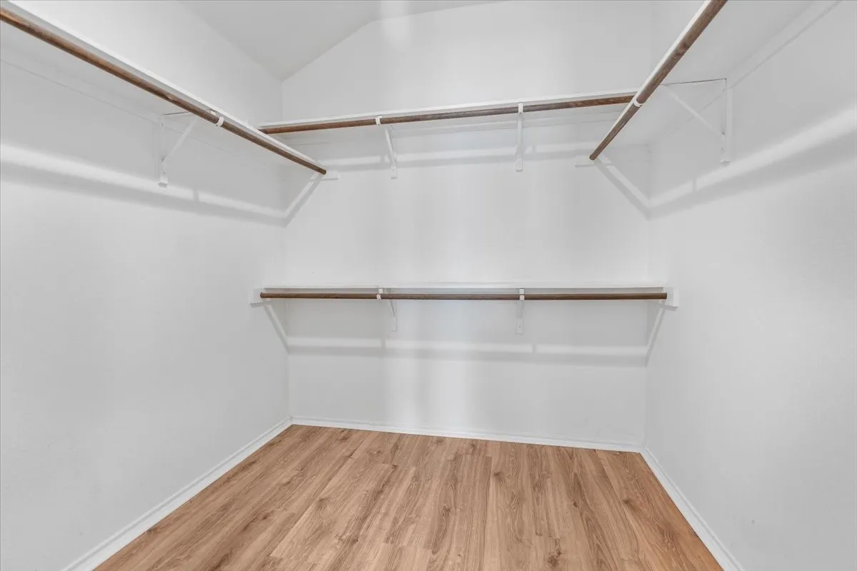 Spacious closet featuring wood finished floors