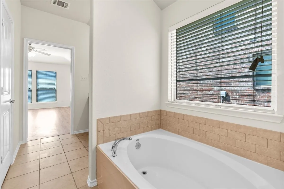 Bathroom featuring a garden tub and tile patterned floors