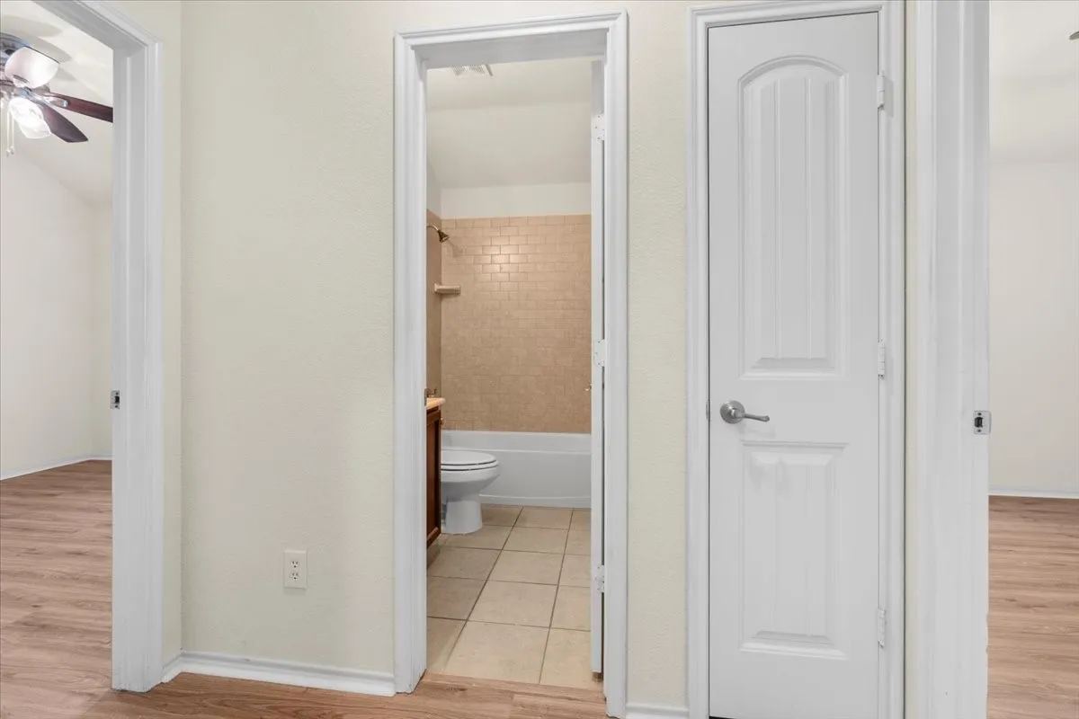 Full bathroom featuring wood finished floors and shower / bath combination