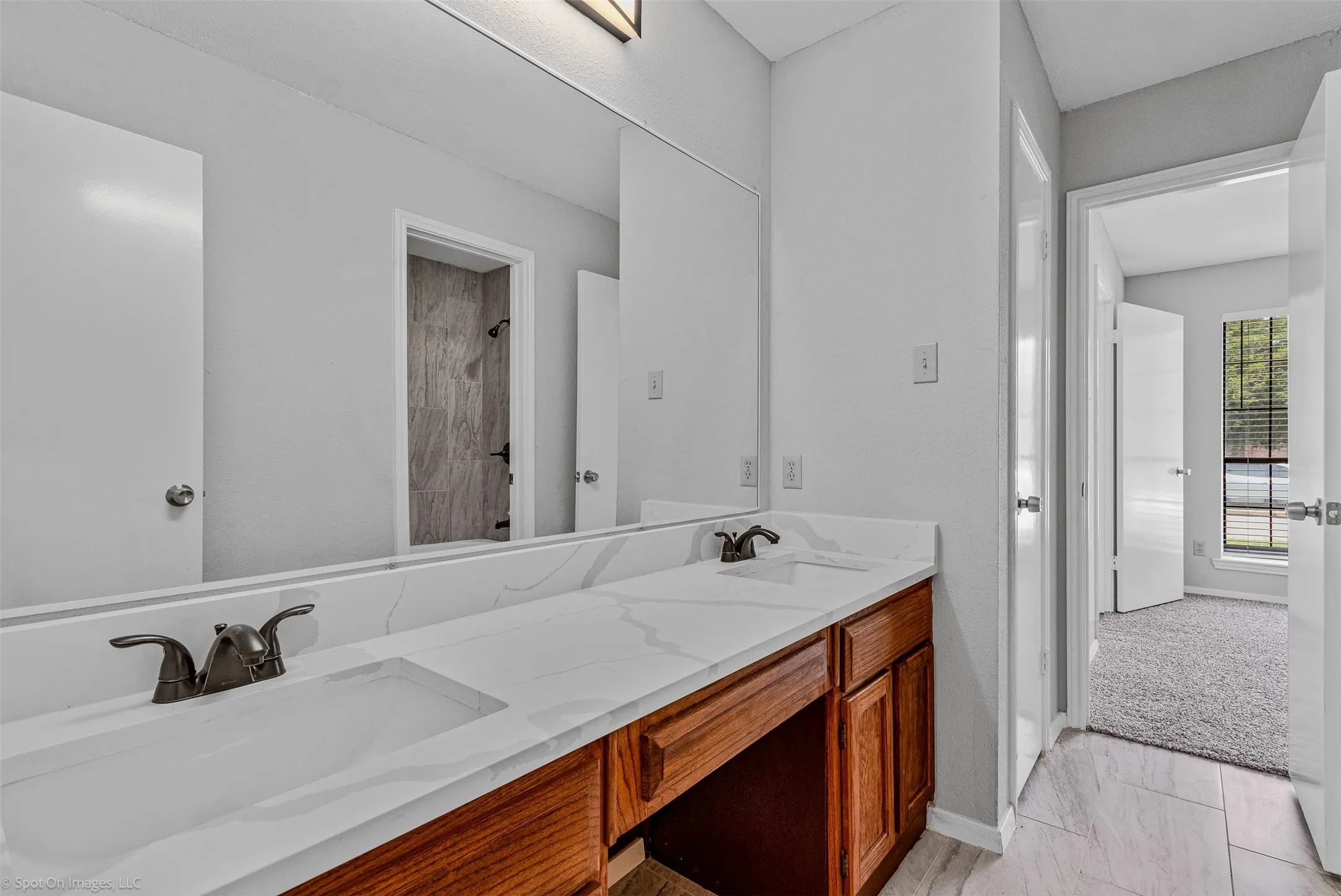 Full bath with a sink and a tile shower
