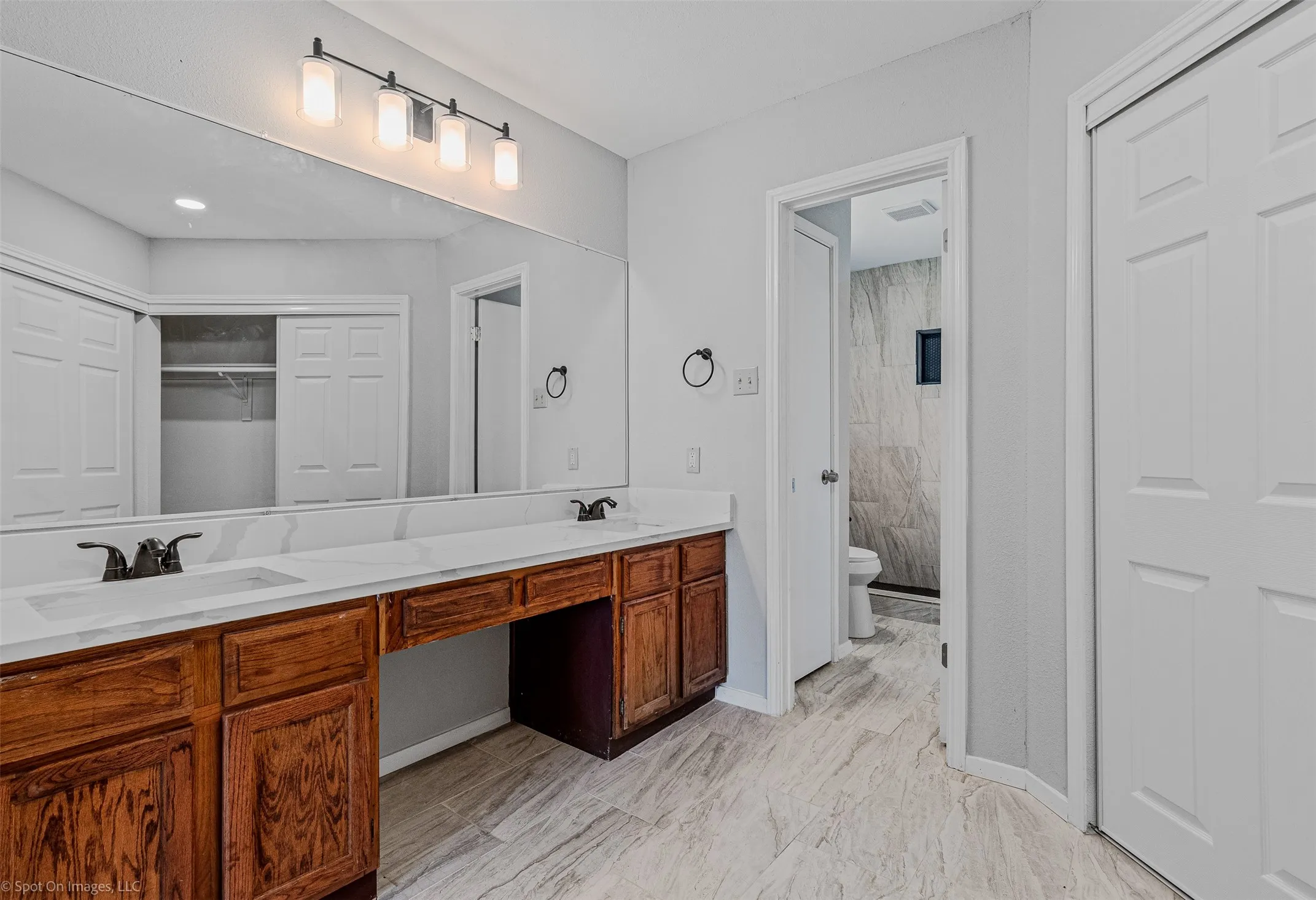 Full bath featuring a sink and a closet