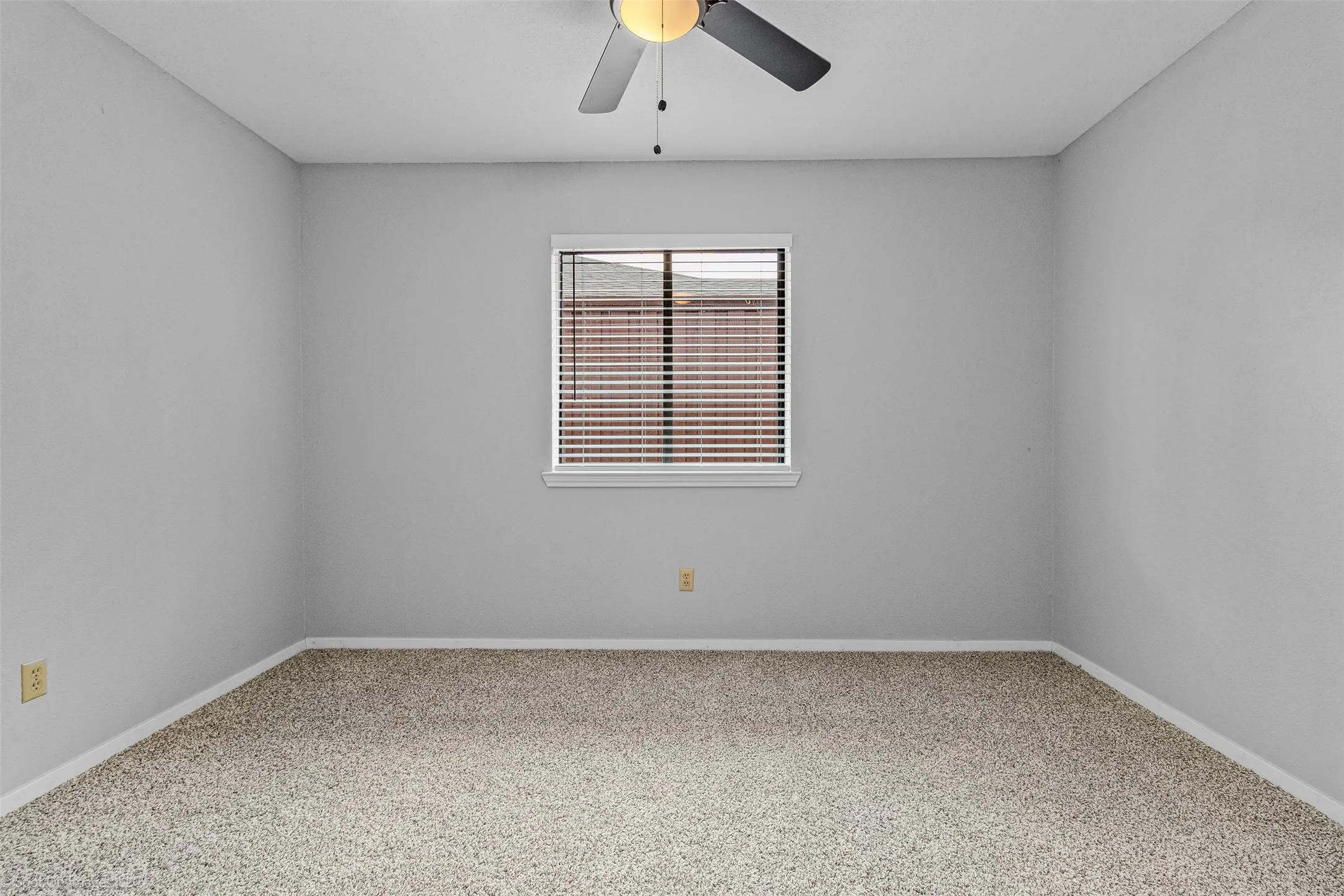 Unfurnished room with baseboards and a ceiling fan