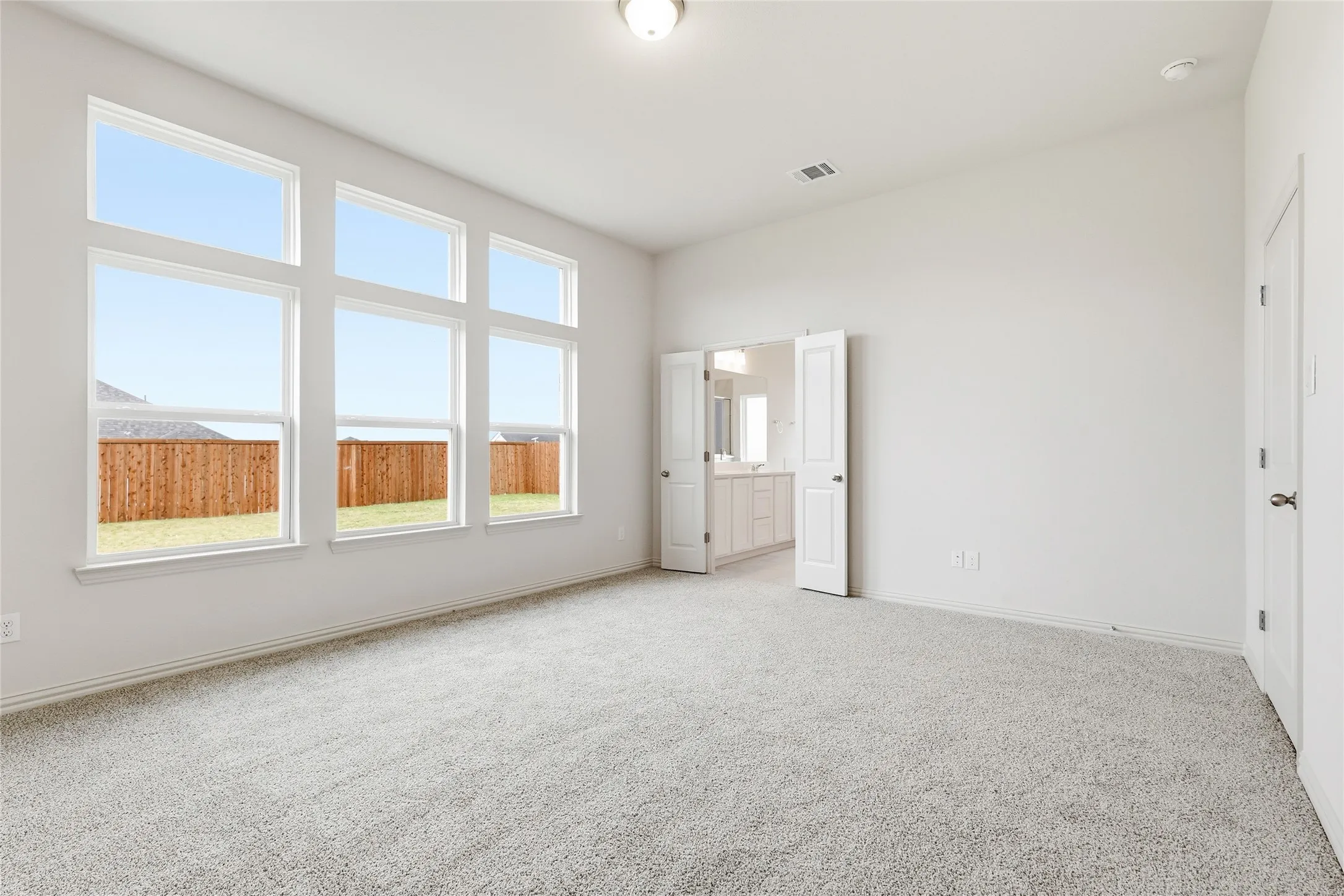 Unfurnished bedroom with carpet and baseboards
