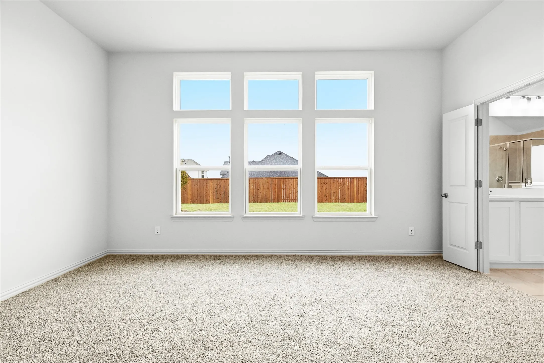 Unfurnished room featuring light colored carpet and baseboards