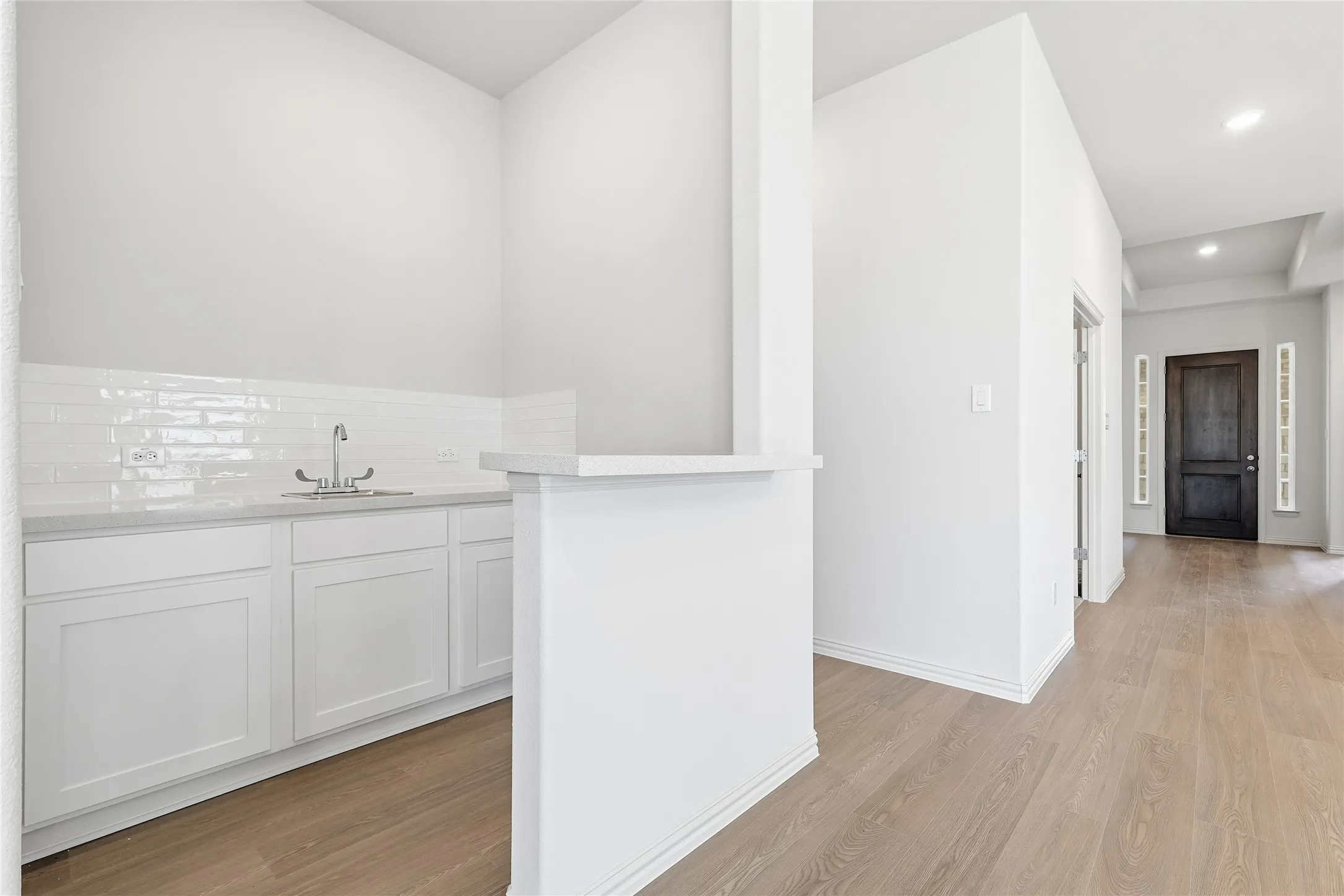 Bar with white cabinets, recessed lighting, and light wood finished floors