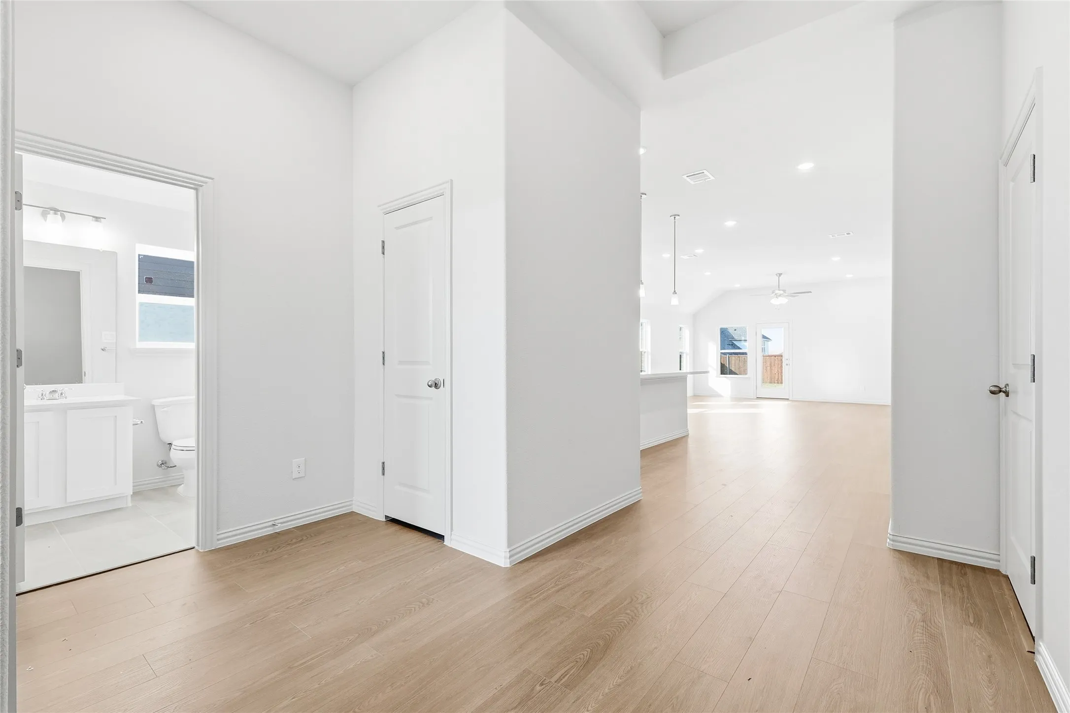 Hall with light wood-style flooring and recessed lighting
