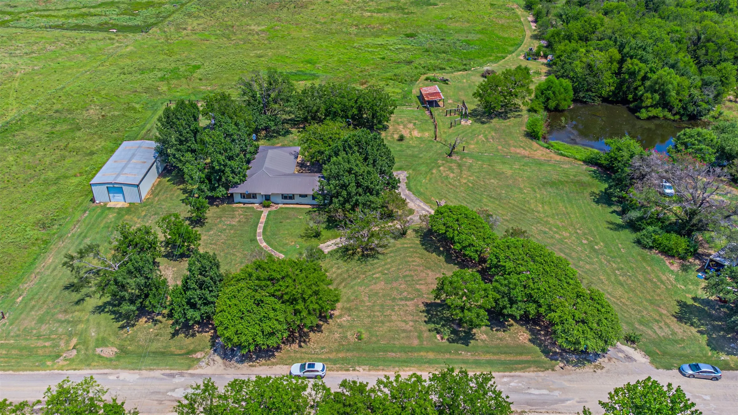 Aerial view of property and surrounding area featuring a large body of water